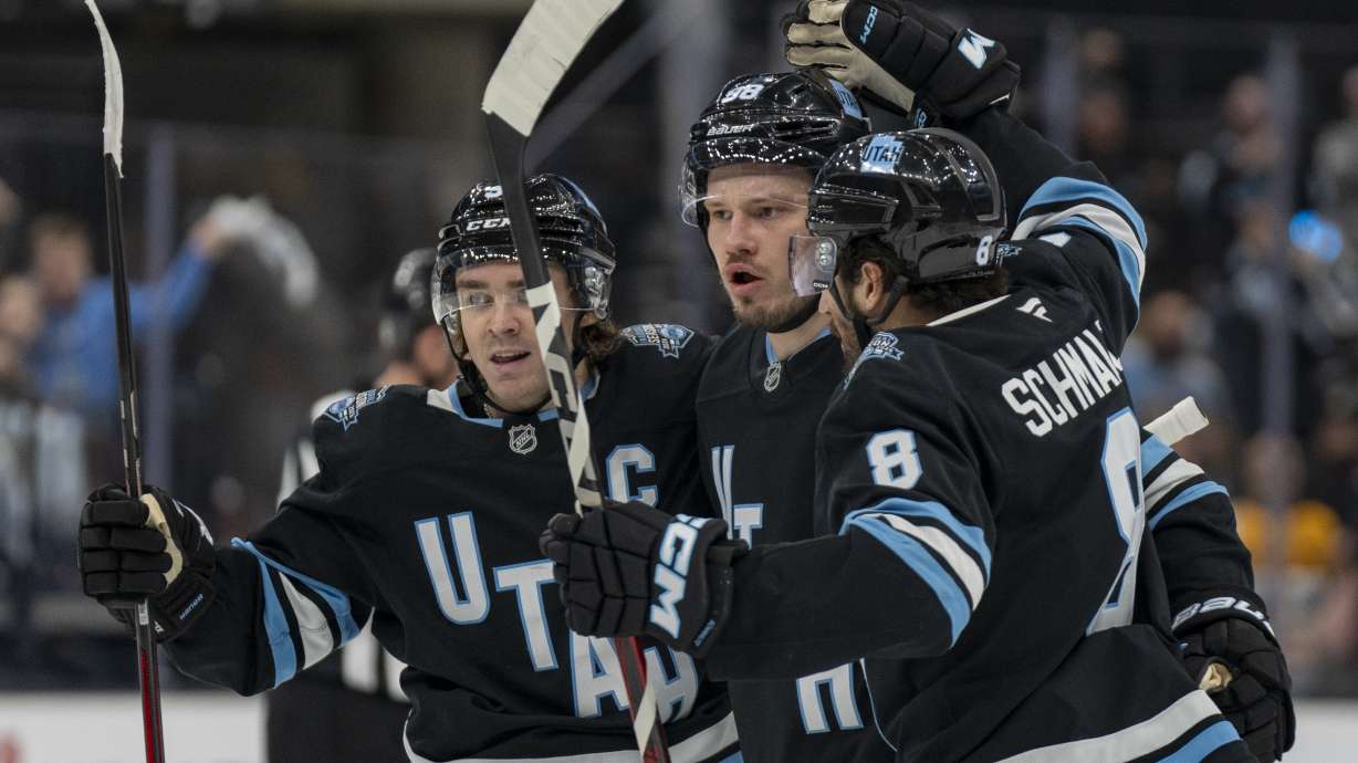 Utah Hockey Club center Clayton Keller, left, Utah Hockey Club defenseman Mikhail Sergachev (middle) Utah Hockey Club center Nick Schmaltz, right, celebrate Sergachev's goal, during the first period of an NHL hockey game Wednesday, Jan. 29, 2025, in Salt Lake City.
