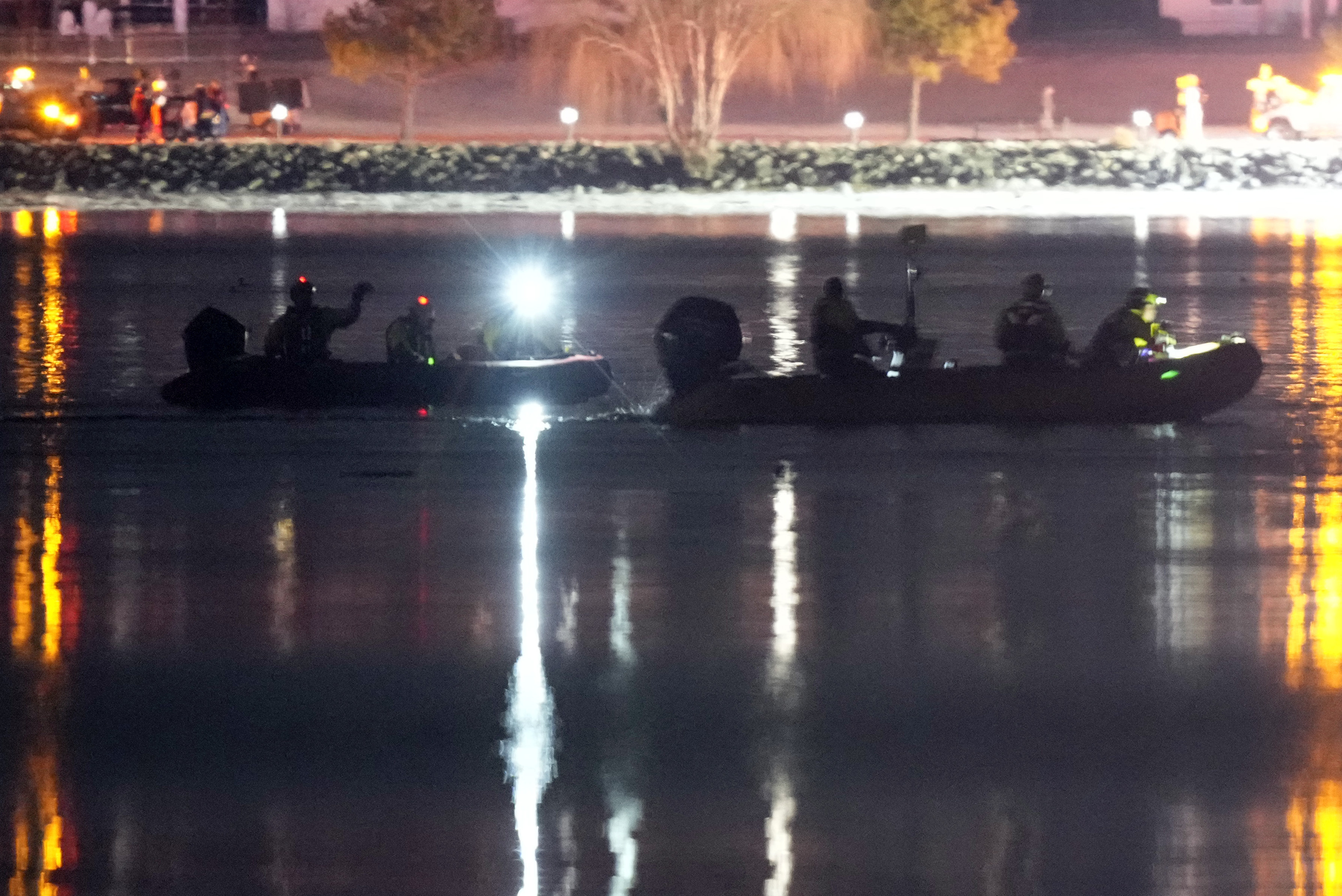 Boats work the scene in the Potomac River near Ronald Reagan Washington National Airport, Thursday, Jan. 30, 2025, in Arlington, Va.