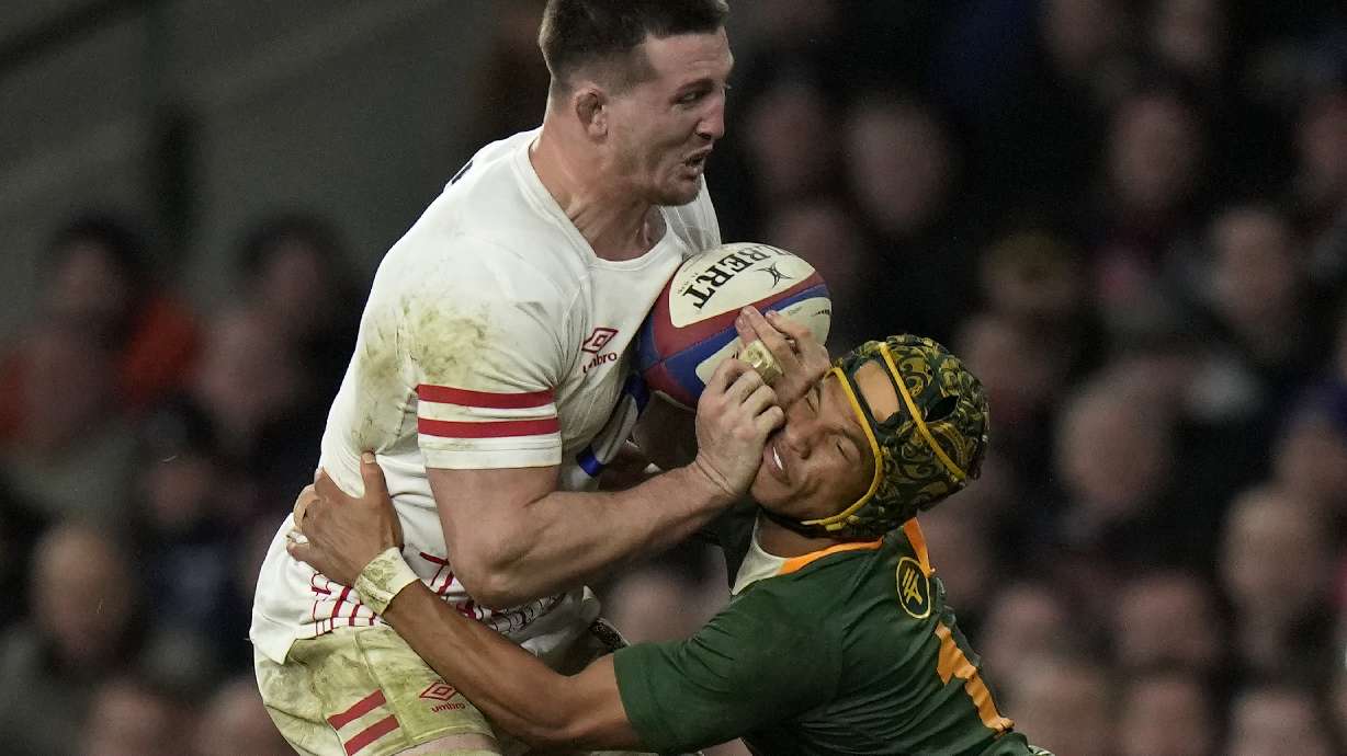 FILE - England's Tom Curry, left, collides with South Africa's Kurt-Lee Arendse during the international rugby match between England and South Africa at Twickenham stadium in London, Saturday, Nov. 26, 2022.