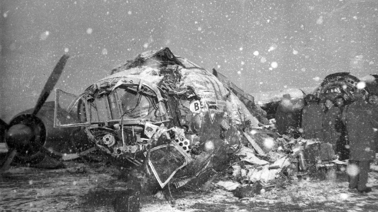 FILE - Snow falls on the wreck of a BEA Elizabethan Airliner which crashed on take-off at Munich, Germany, Feb. 6, 1958, killing 21 people, including seven members of the Manchester United football team. The Manchester United football team were returning from Yugoslavia where they had played a European Cup quarter final against Red Star Belgrade the day before.
