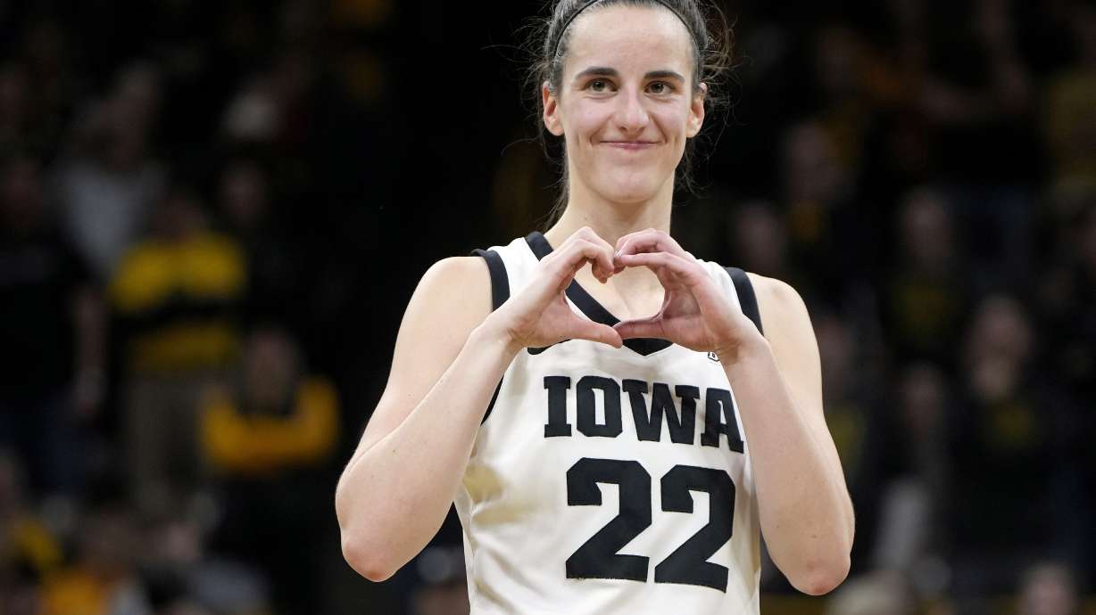 FILE - Iowa guard Caitlin Clark makes a heart gesture after the team's NCAA college basketball game against Michigan, Thursday, Feb. 15, 2024, in Iowa City, Iowa. Clark broke the NCAA women's career scoring record.