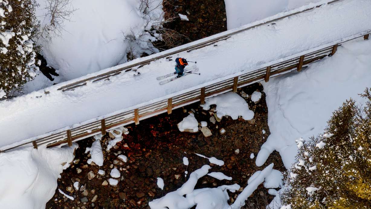 A skier crosses a bridge in the snow in Little Cottonwood Canyon on Sunday. Parts of Utah are in line for some heavy moisture after a relatively dry January.