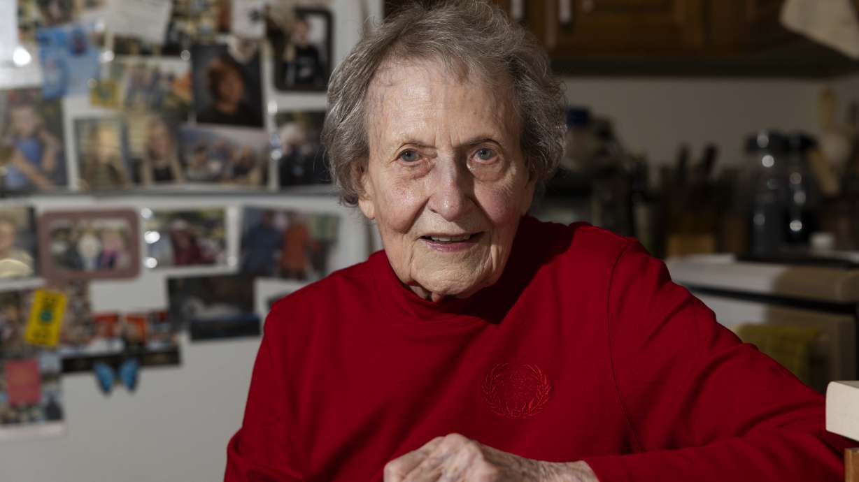Donna Norton, soon to be 104 years old, poses for a portrait in the kitchen of her apartment in Cottonwood Heights on Wednesday. Her refrigerator is decorated with photos of her 10 grandchildren and 14 great-grandchildren.