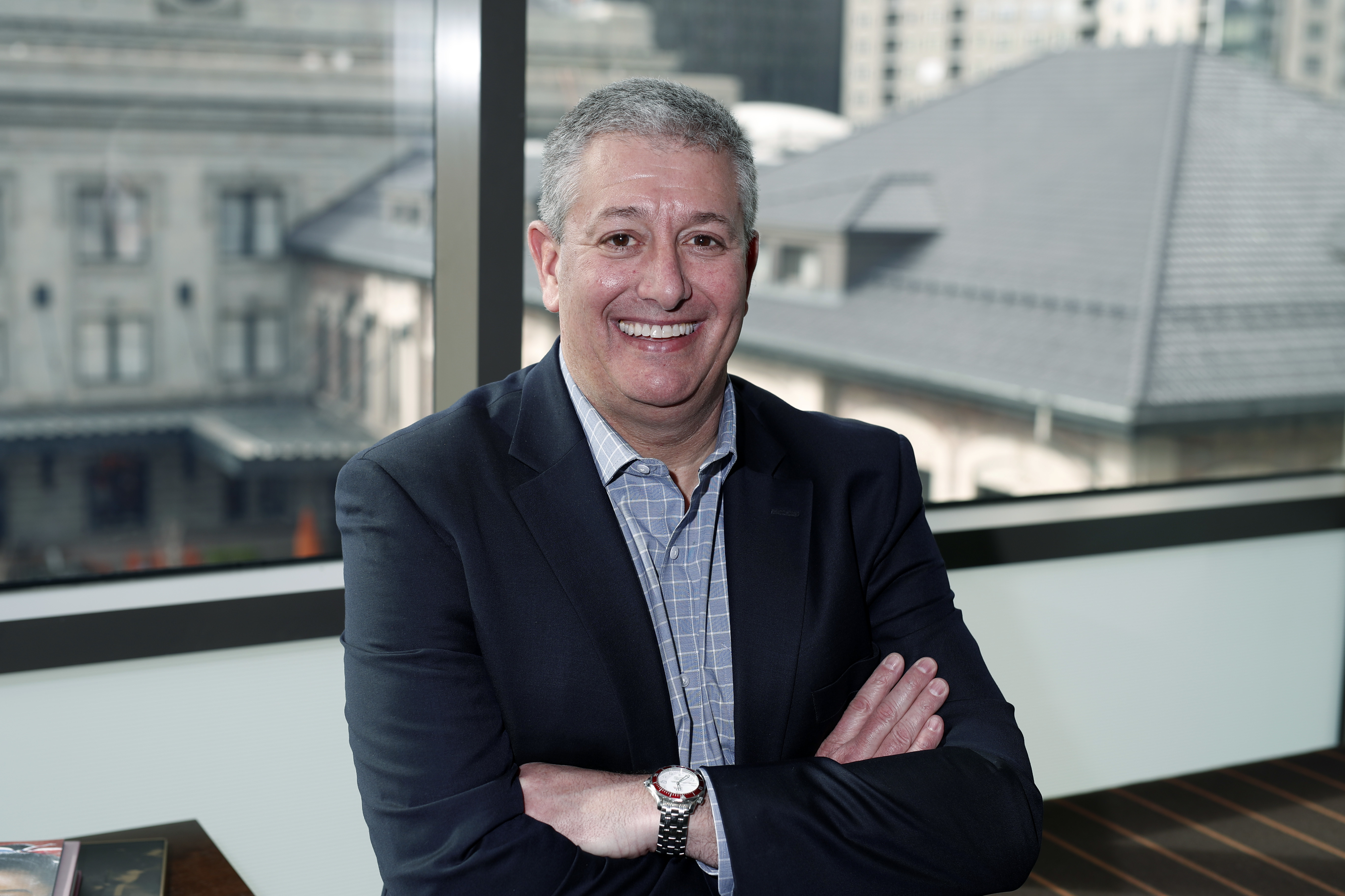 FILE - In this Jan. 31, 2018, photo, Rob Cohen, who is spearheading Colorado's effort to secure an Olympic bid, poses in his office in lower downtown Denver. 