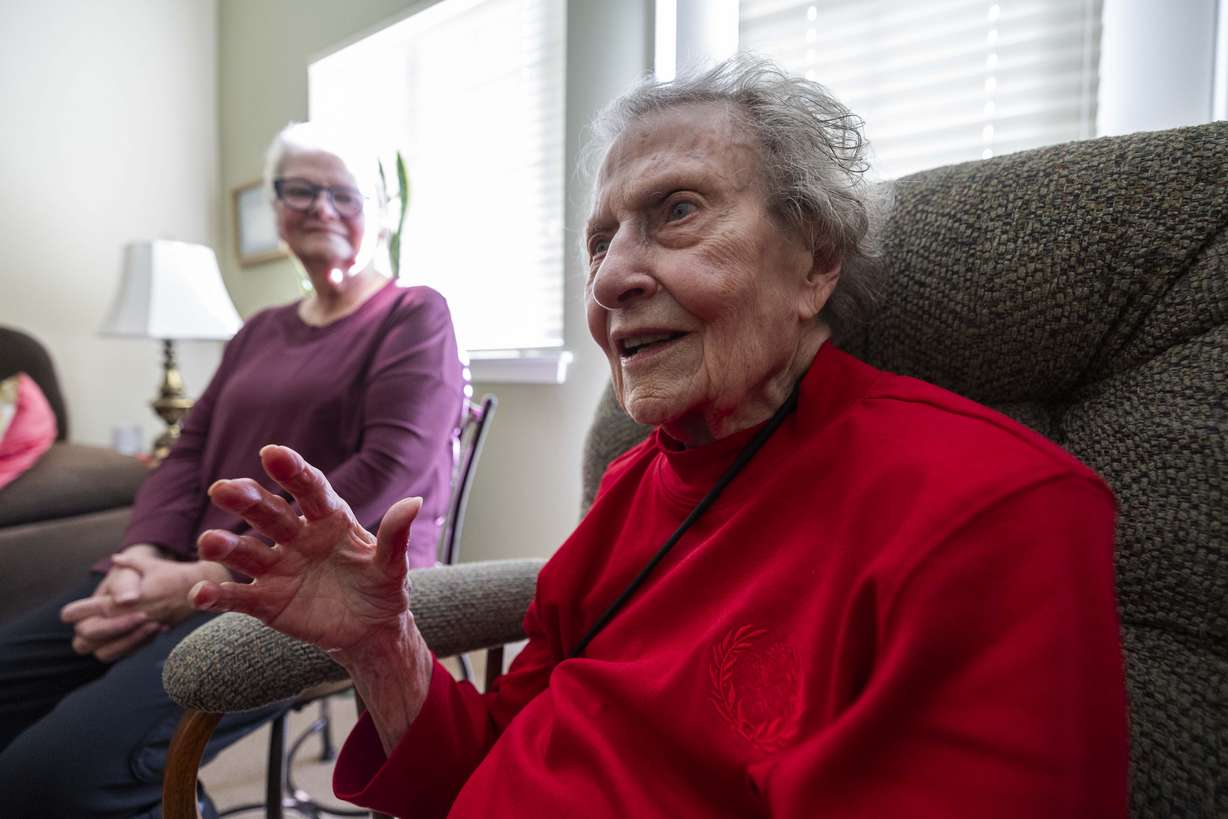 Donna Norton, soon to be a 104-year-old, right, laughs with her daughter Debbie Thorn, left, during an interview in the living room of her apartment in the Escalante at Coventry Senior Living facility in Cottonwood Heights on Wednesday.