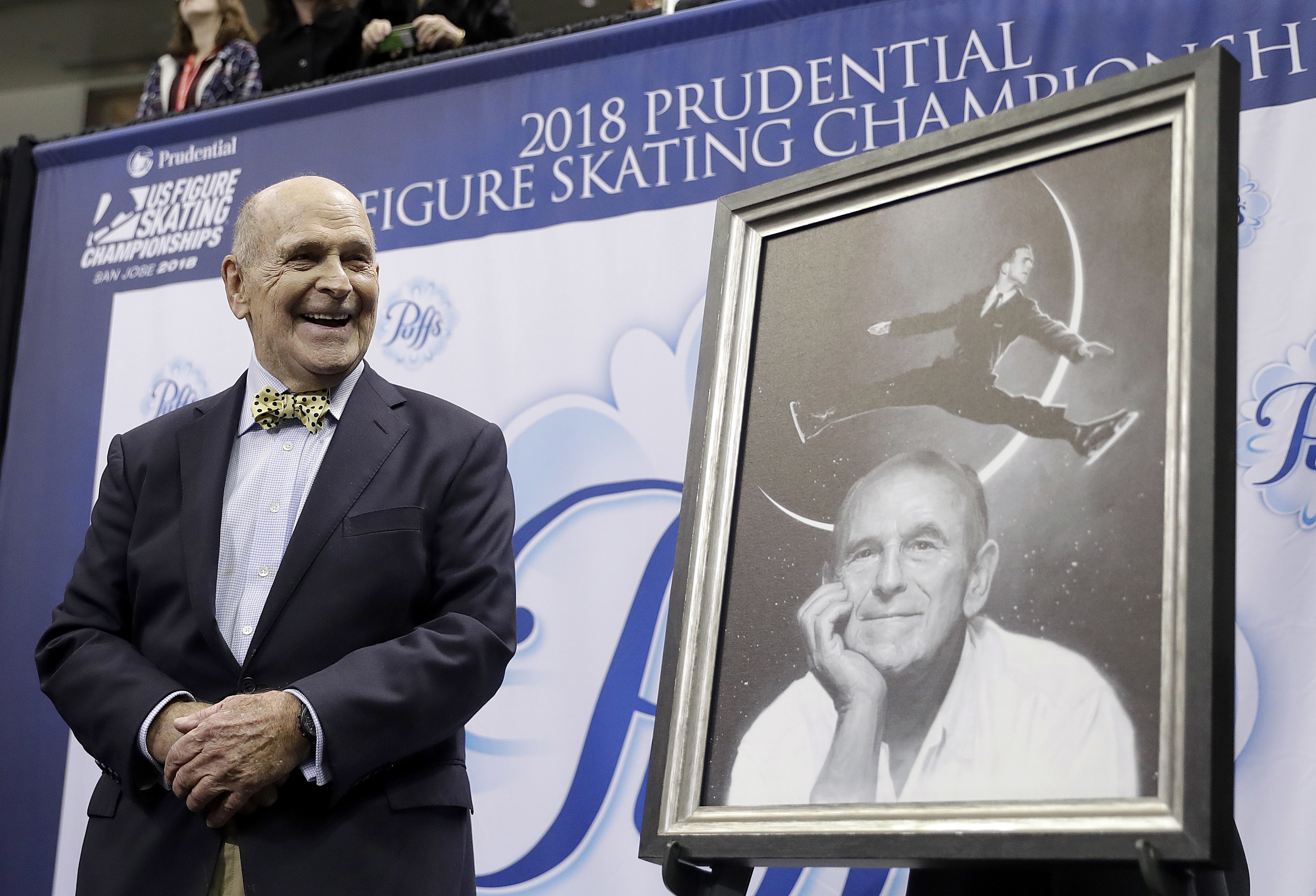 FILE - Dick Button smiles next to a painting of him while honored at the U.S. Figure Skating Championships in San Jose, Calif., Thursday, Jan. 4, 2018.