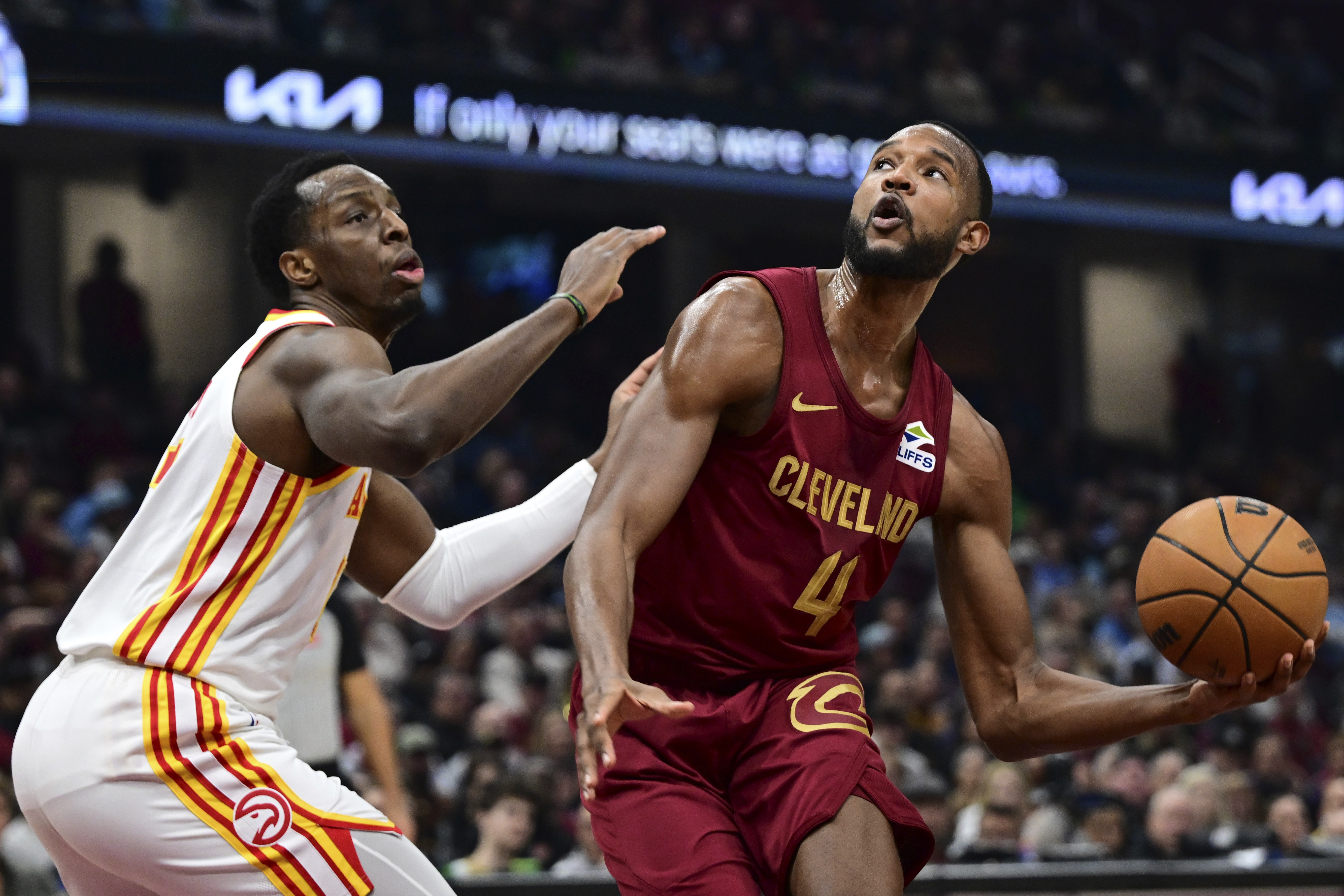 Cleveland Cavaliers forward Evan Mobley (4) goes to the basket against Atlanta Hawks forward Onyeka Okongwu, left, in the first half of an NBA basketball game, Thursday, Jan. 30, 2025, in Cleveland. 