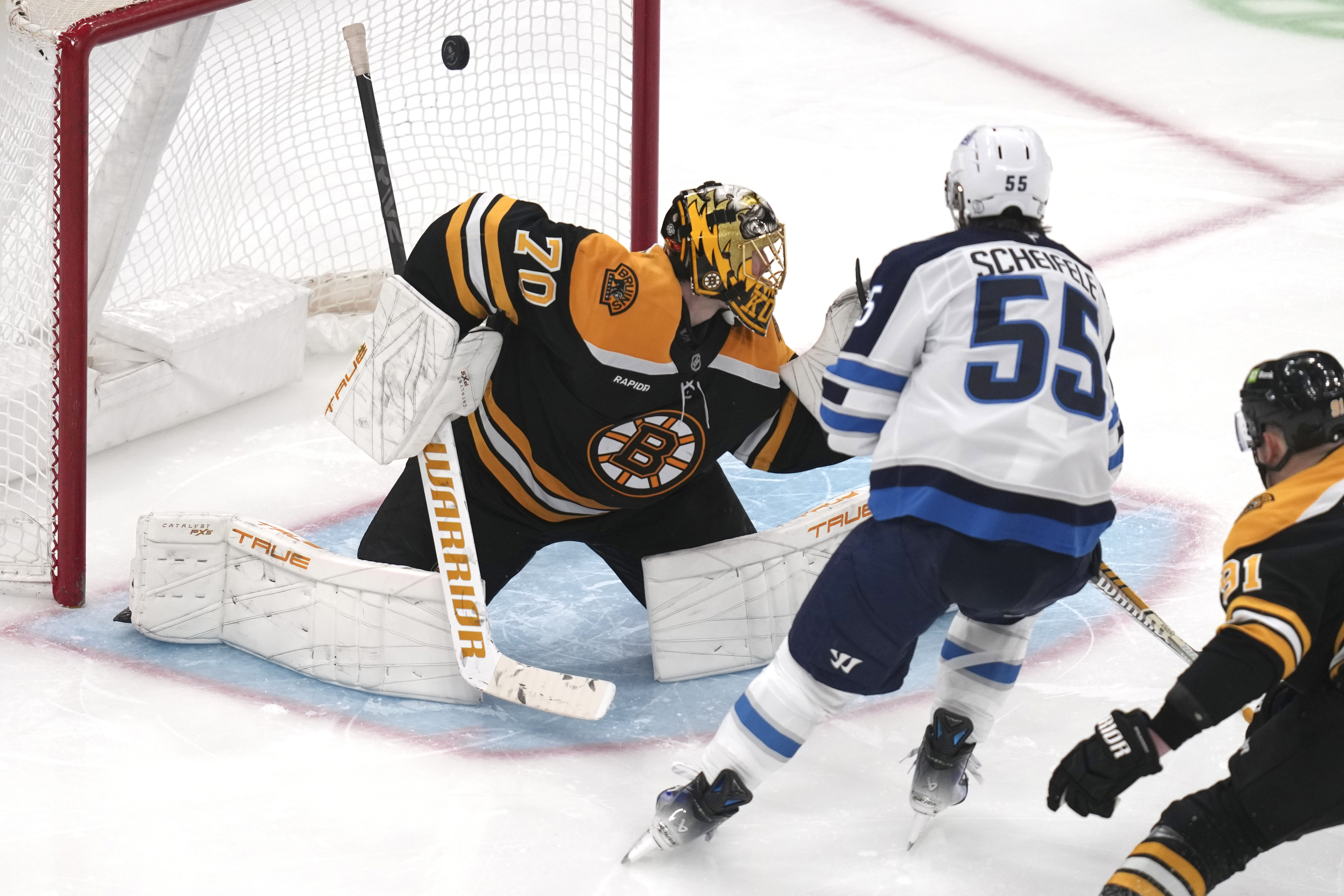 Winnipeg Jets center Mark Scheifele (55) shoots the puck past Boston Bruins goaltender Joonas Korpisalo (70) for a goal during the third period of an NHL hockey game, Thursday, Jan. 30, 2025, in Boston. 
