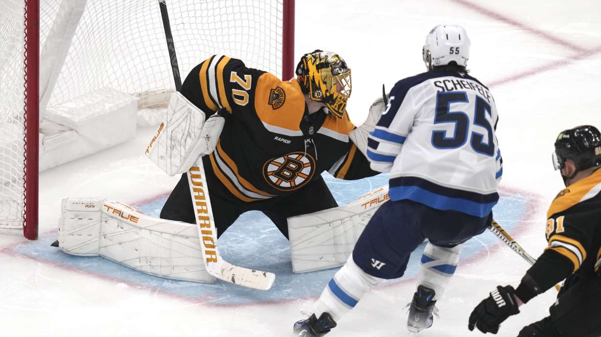 Winnipeg Jets center Mark Scheifele (55) shoots the puck past Boston Bruins goaltender Joonas Korpisalo (70) for a goal during the third period of an NHL hockey game, Thursday, Jan. 30, 2025, in Boston.