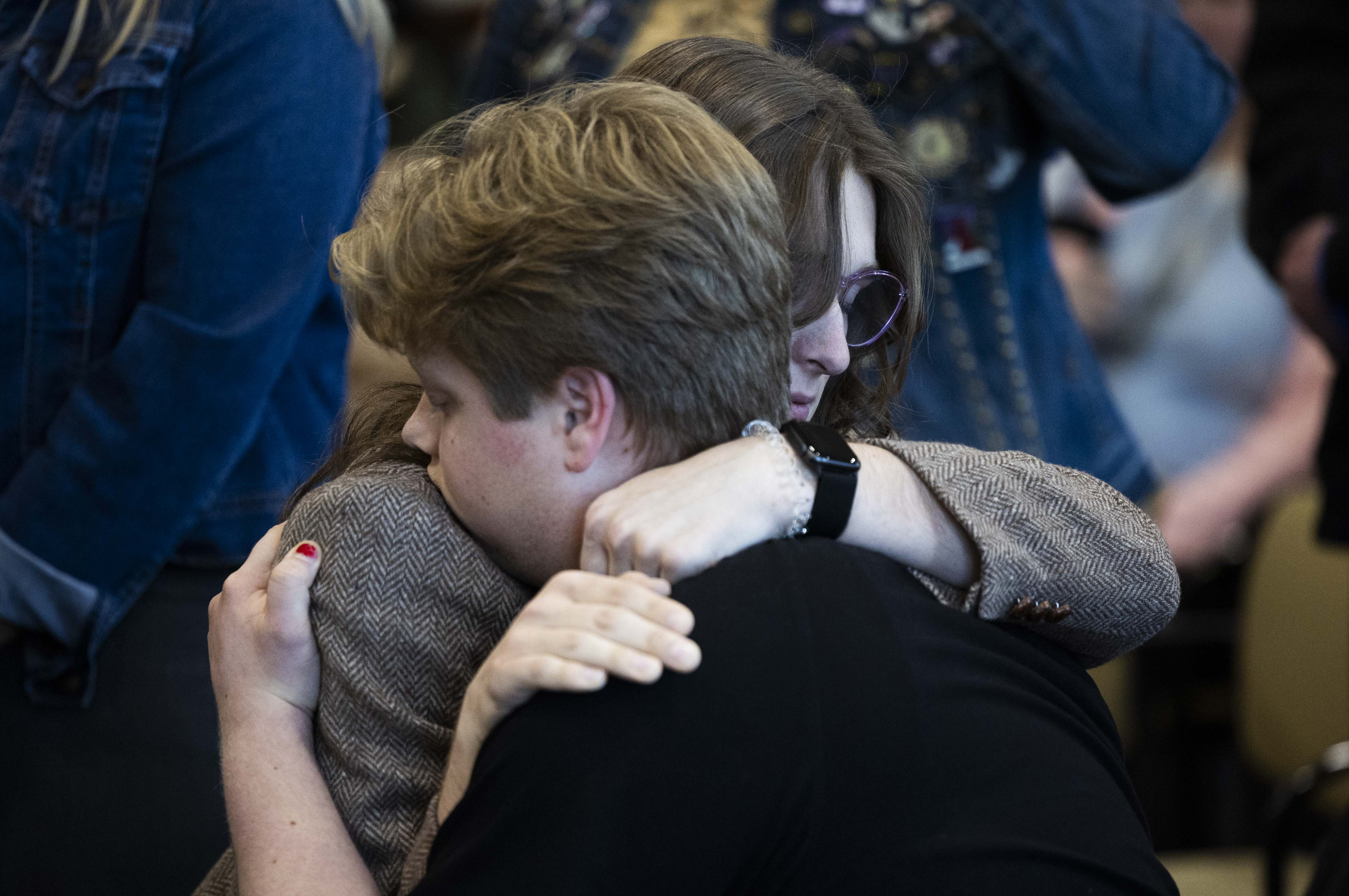 Marcie Robertson, a 20-year-old transgender Utah State University student and resident assistant, hugs her brother Ezra Robertson after speaking at a hearing on HB269, which pertains to privacy protections in sex-designated areas, in the Senate Education standing committee in Salt Lake City on Thursday.