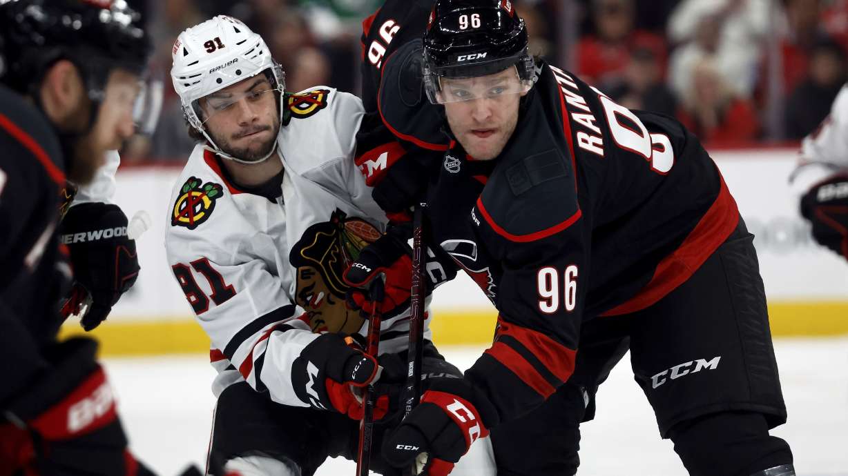 Carolina Hurricanes' Mikko Rantanen (96) battles with Chicago Blackhawks' Frank Nazar (91) following a face off during the first period of an NHL hockey game in Raleigh, N.C., Thursday, Jan. 30, 2025.