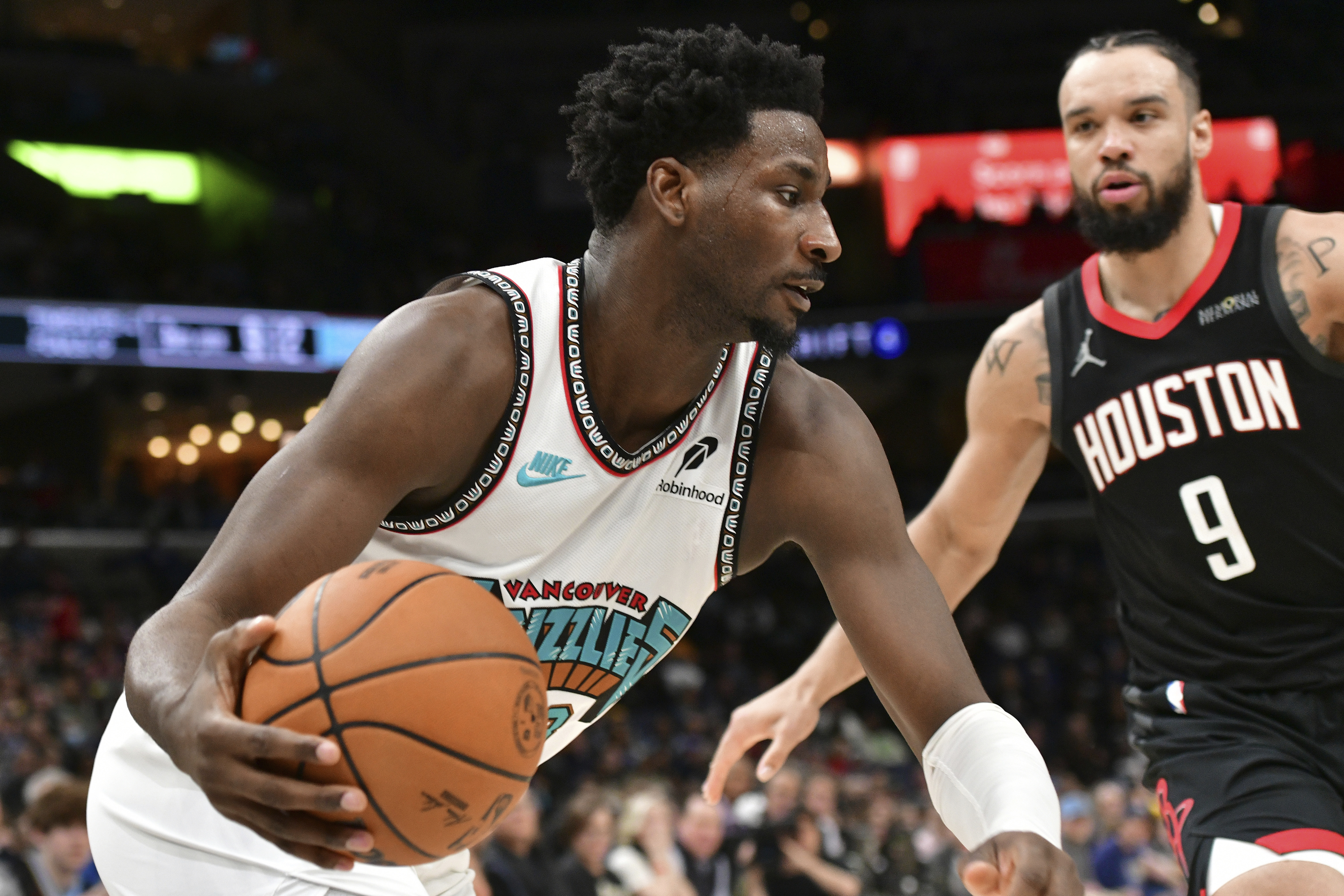 Memphis Grizzlies forward Jaren Jackson Jr., left, handles the ball against Houston Rockets forward Dillon Brooks (9) in the second half of an NBA basketball game Thursday, Jan. 30, 2025, in Memphis, Tenn. 