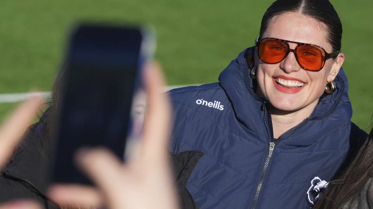 Bristol Bears' Ilona Maher poses for photographs with fans ahead of the women's rugby union match between Ealing Trailfinders and Bristol Bears at the Trailfinders Sports Ground in London, Saturday, Jan. 25, 2025.