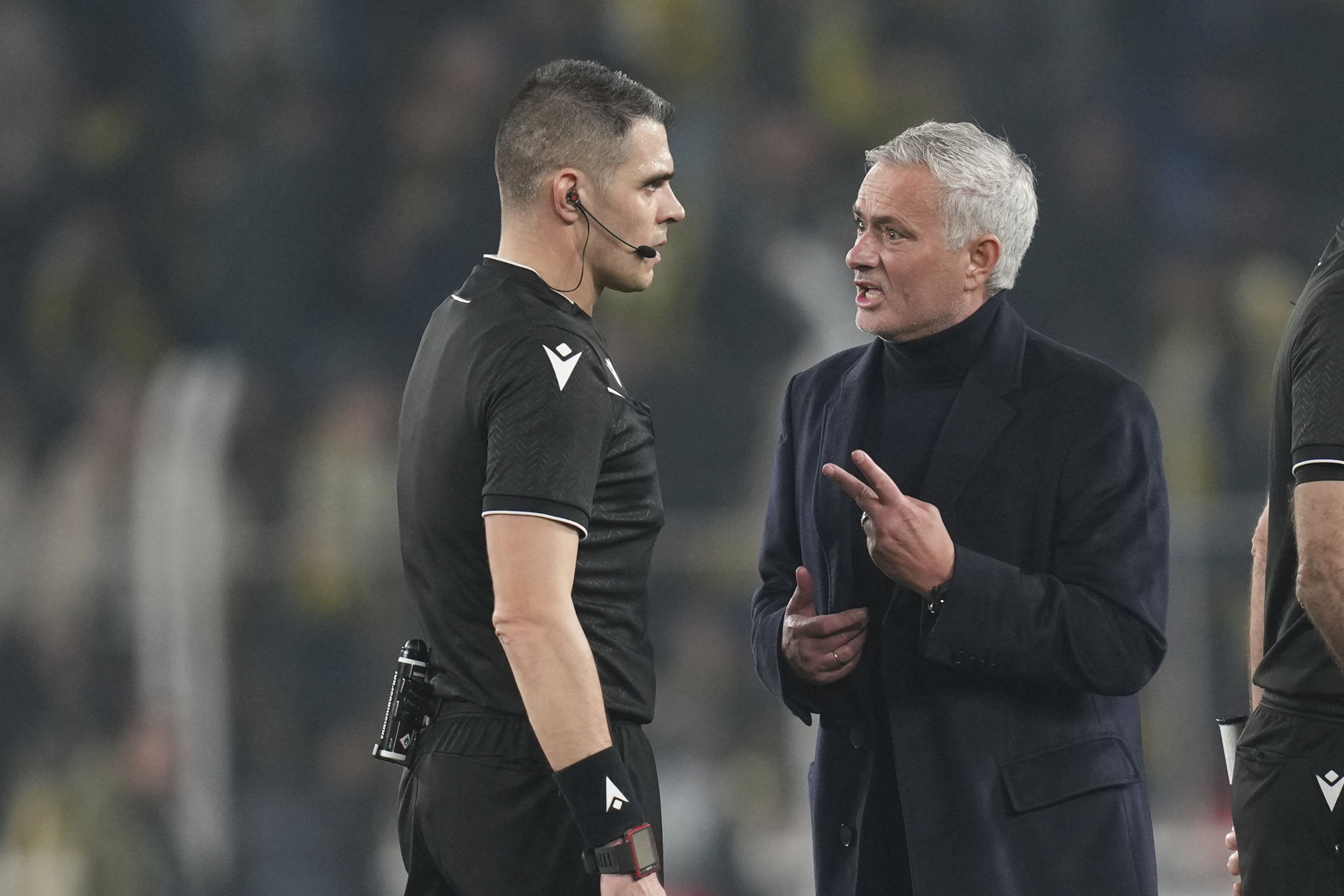 Fenerbahce's head coach Jose Mourinho, right, argues with the referee Simone Sozza at the end of the Europa League opening phase soccer match against Lyon at Sukru Saracoglu stadium in Istanbul, Turkey, Thursday, Jan. 23, 2025. 