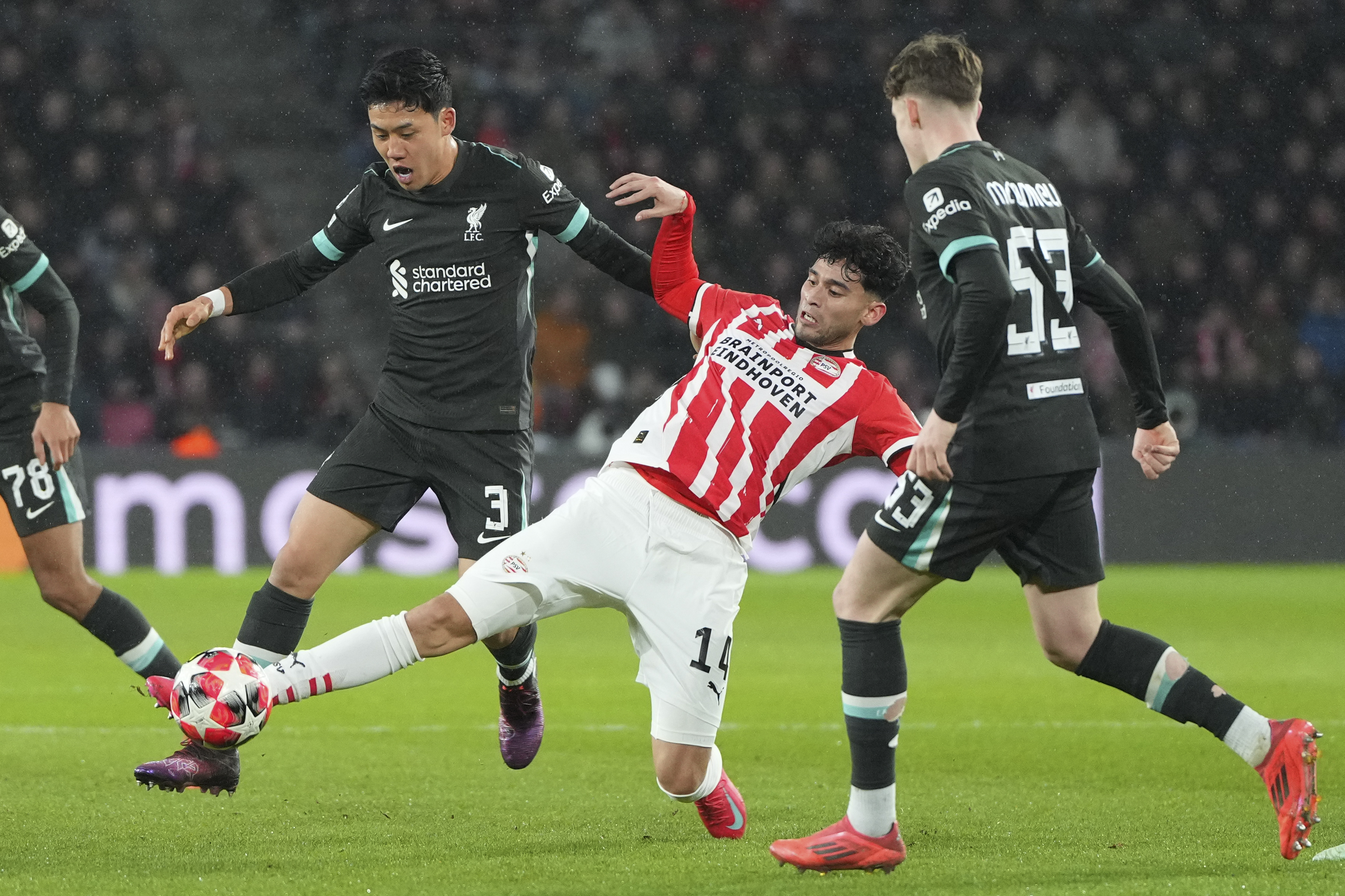 Liverpool's Wataru Endo, left, and PSV's Ricardo Pepi fight for the ball during the Champions League opening phase soccer match between PSV and Liverpool at Phillips Stadium in Eindhoven, Netherlands, Wednesday, Jan. 29, 2025.