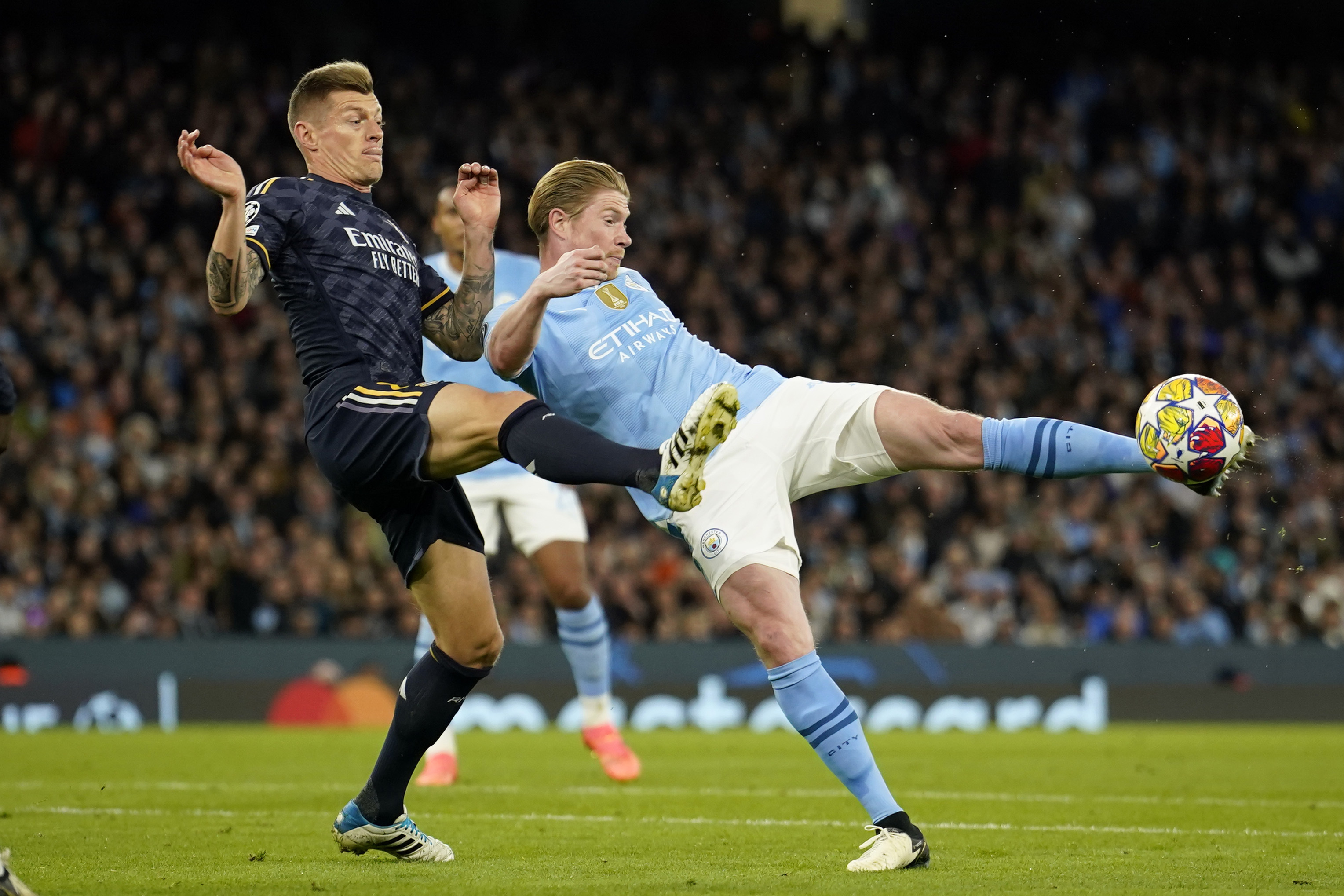 FILE - Manchester City's Kevin De Bruyne kicks the ball with Real Madrid's Toni Kroos during the Champions League quarterfinal second leg soccer match between Manchester City and Real Madrid at the Etihad Stadium in Manchester, England, Wednesday, April 17, 2024.