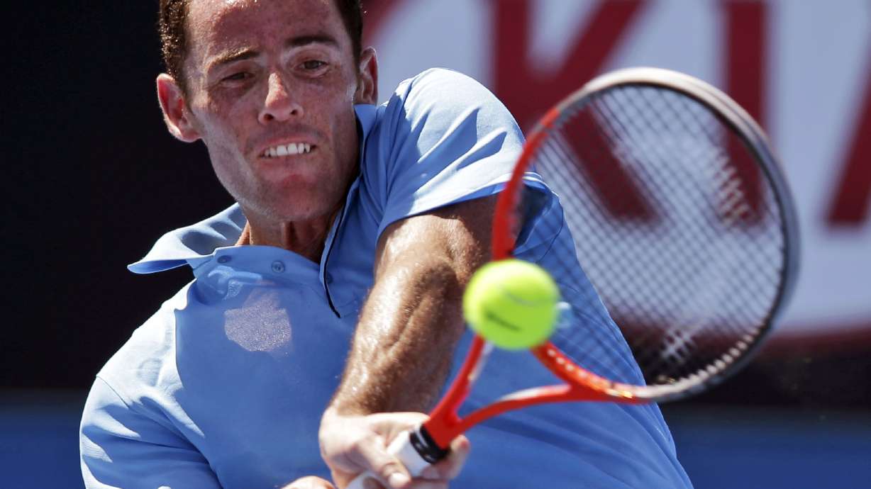 France's David Guez hits a shot to compatriot Richard Gasquet during their first round match at the Australian Open tennis tournament in Melbourne, Australia, Monday, Jan. 13, 2014.
