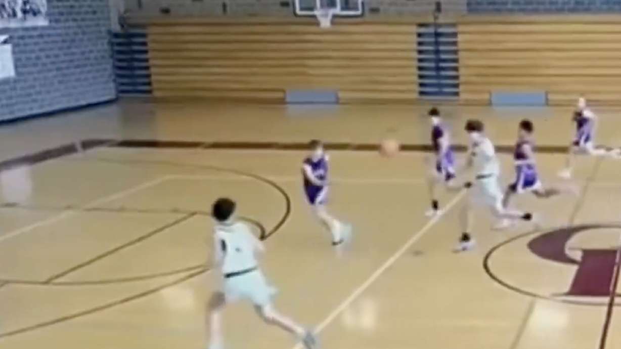Almost immediately after receiving the ball, No. 7 is about to get trucked by a bench being pushed across the floor mid-action for whatever reason.