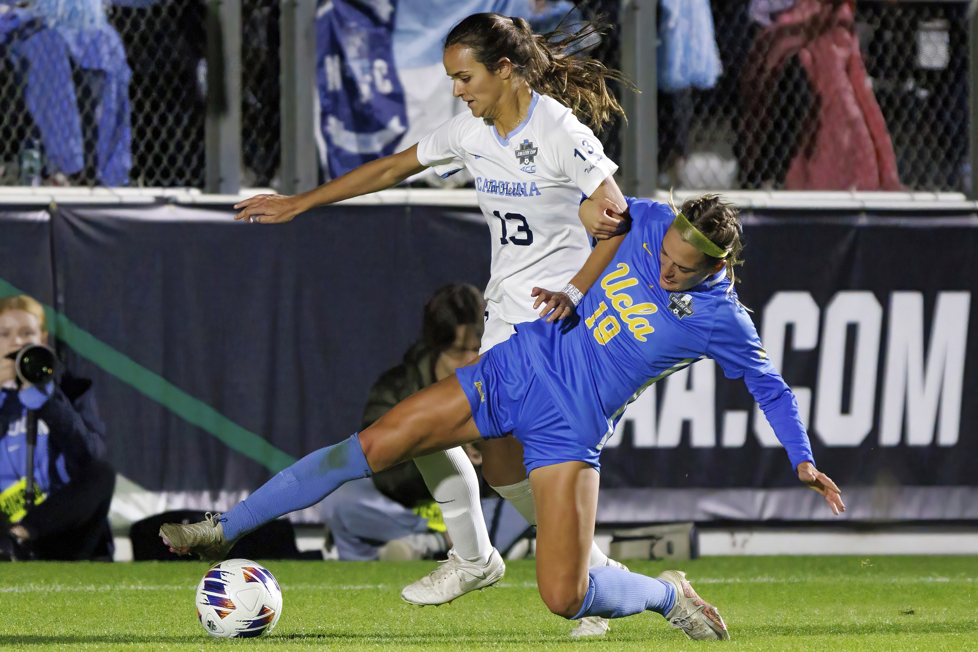 FILE - North Carolina's Isabel Coxs (13) and UCLA's Quincy McMahon (19) battle for a ball during the second half of the NCAA women's soccer tournament final in Cary, N.C., Monday, Dec. 5, 2022. 