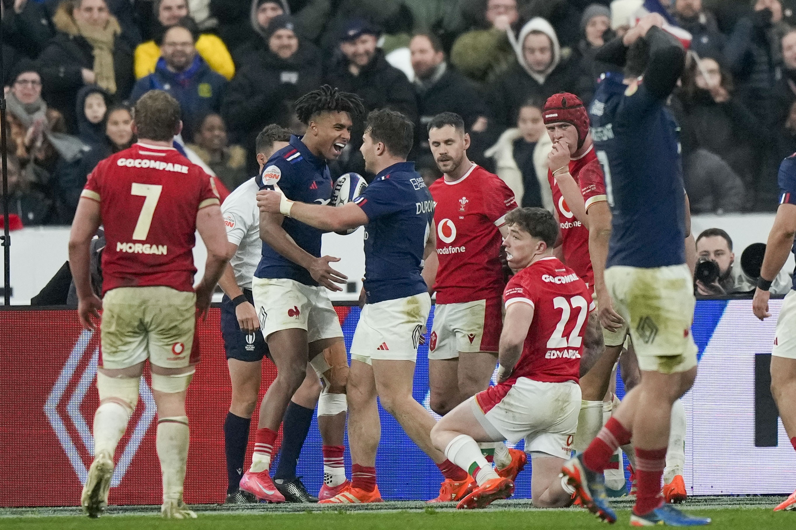 France's Theo Attissogbe, second left, celebrates with Antoine Dupont after scoring a try during the Six Nations rugby union match between France and Wales at the Stade de France in Saint-Denis, outside Paris, Friday, Jan. 31, 2025. 