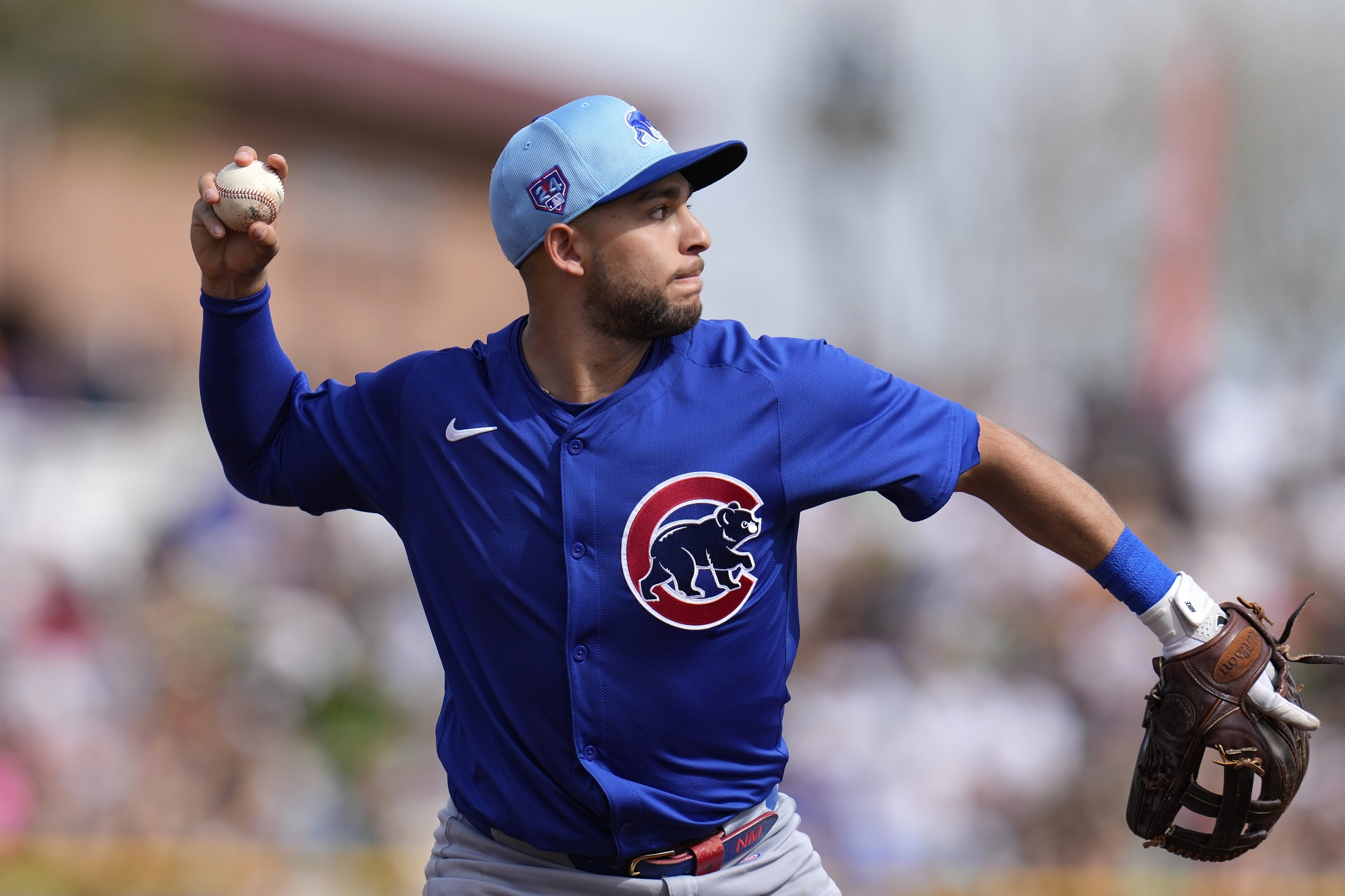 File - Chicago Cubs third baseman Nick Madrigal throws to first base to get San Francisco Giants' Patrick Bailey out during the second inning of a spring training baseball game Saturday, Feb. 24, 2024, in Scottsdale, Ariz.