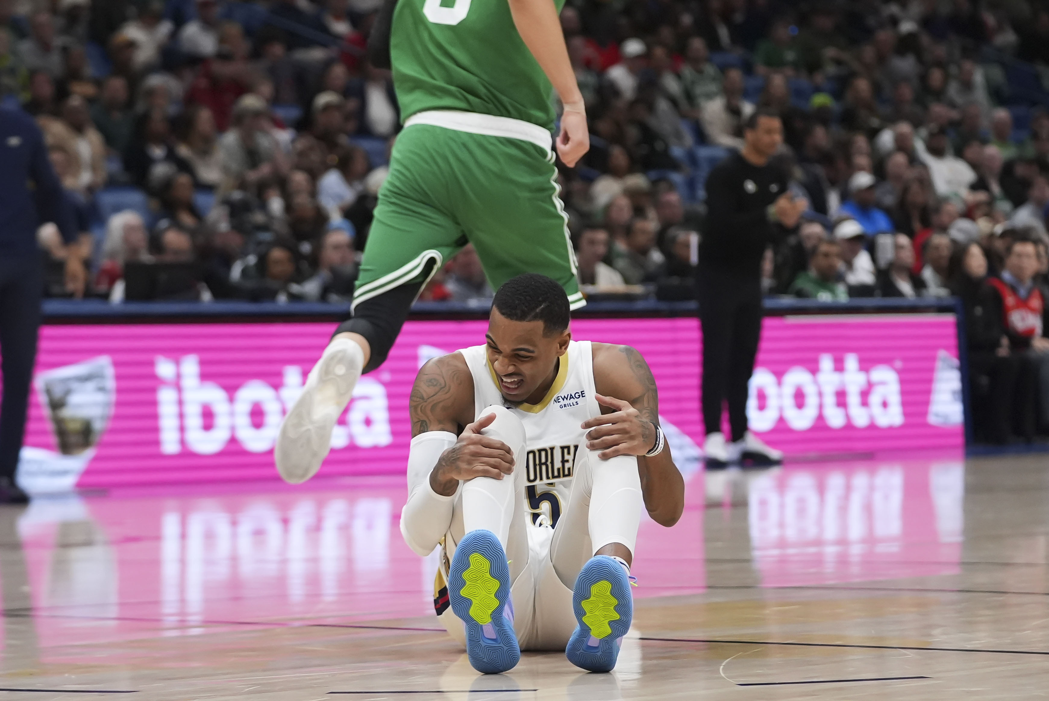 New Orleans Pelicans guard Dejounte Murray (5) reacts after being hurt in the first half of an NBA basketball game against the Boston Celtics in New Orleans, Friday, Jan. 31, 2025. 