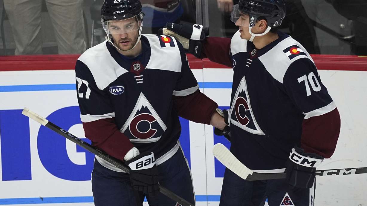 Colorado Avalanche left wing Jonathan Drouin, left, is congratulated after scoring by defenseman Sam Malinski (70) in the first period of an NHL hockey game against the St. Louis Blues Friday, Jan. 31, 2025, in Denver.