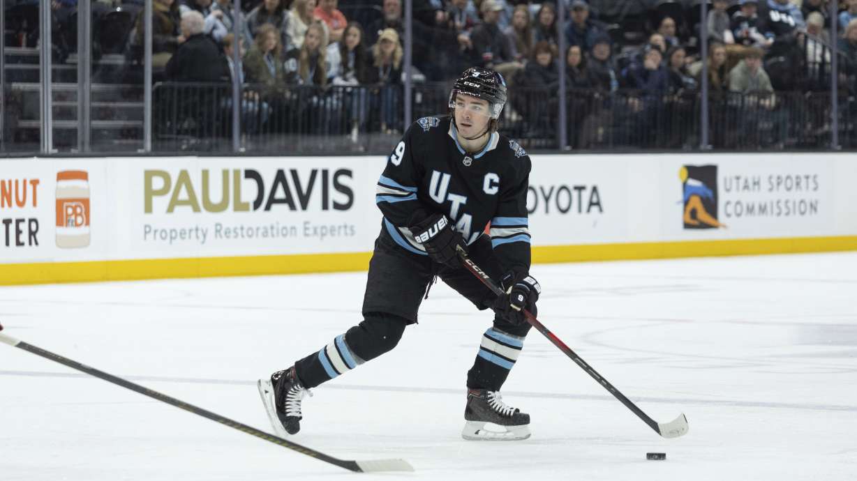 Utah Hockey Club center Clayton Keller (9) moves the puck on the ice against the Columbus Blue Jackets during the first period of an NHL hockey game Friday, Jan. 31, 2025, in Salt Lake City.