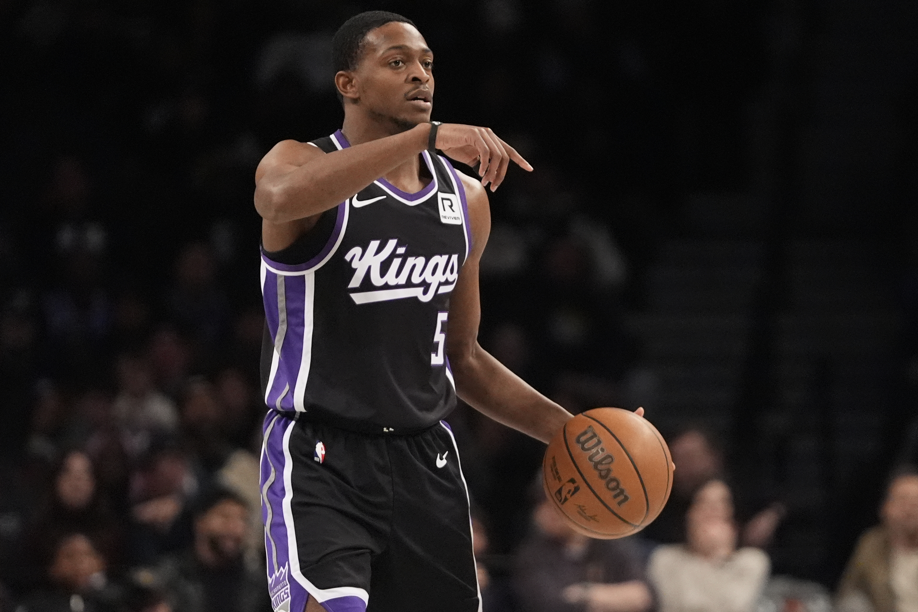 Sacramento Kings' De'Aaron Fox (5) calls out to teammates during the first half of an NBA basketball game against the Brooklyn Nets Monday, Jan. 27, 2025, in New York. 