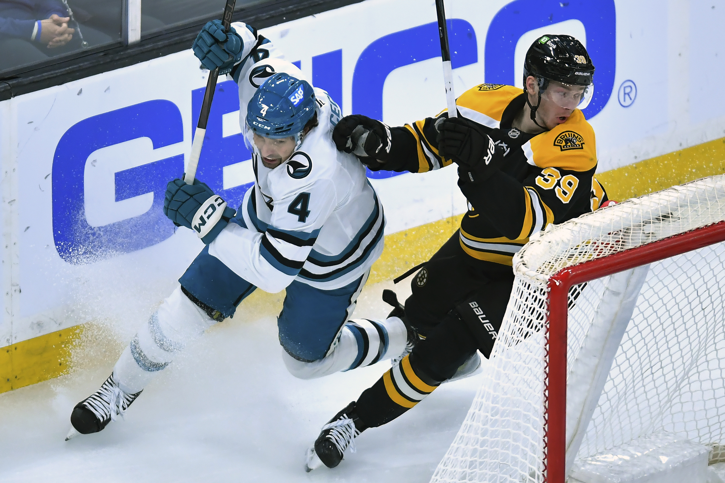 San Jose Sharks defenseman Cody Ceci (4) and Boston Bruins center Morgan Geekie (39) vie for position in the second period of an NHL hockey game, Monday, Jan. 20, 2025, in Boston. 