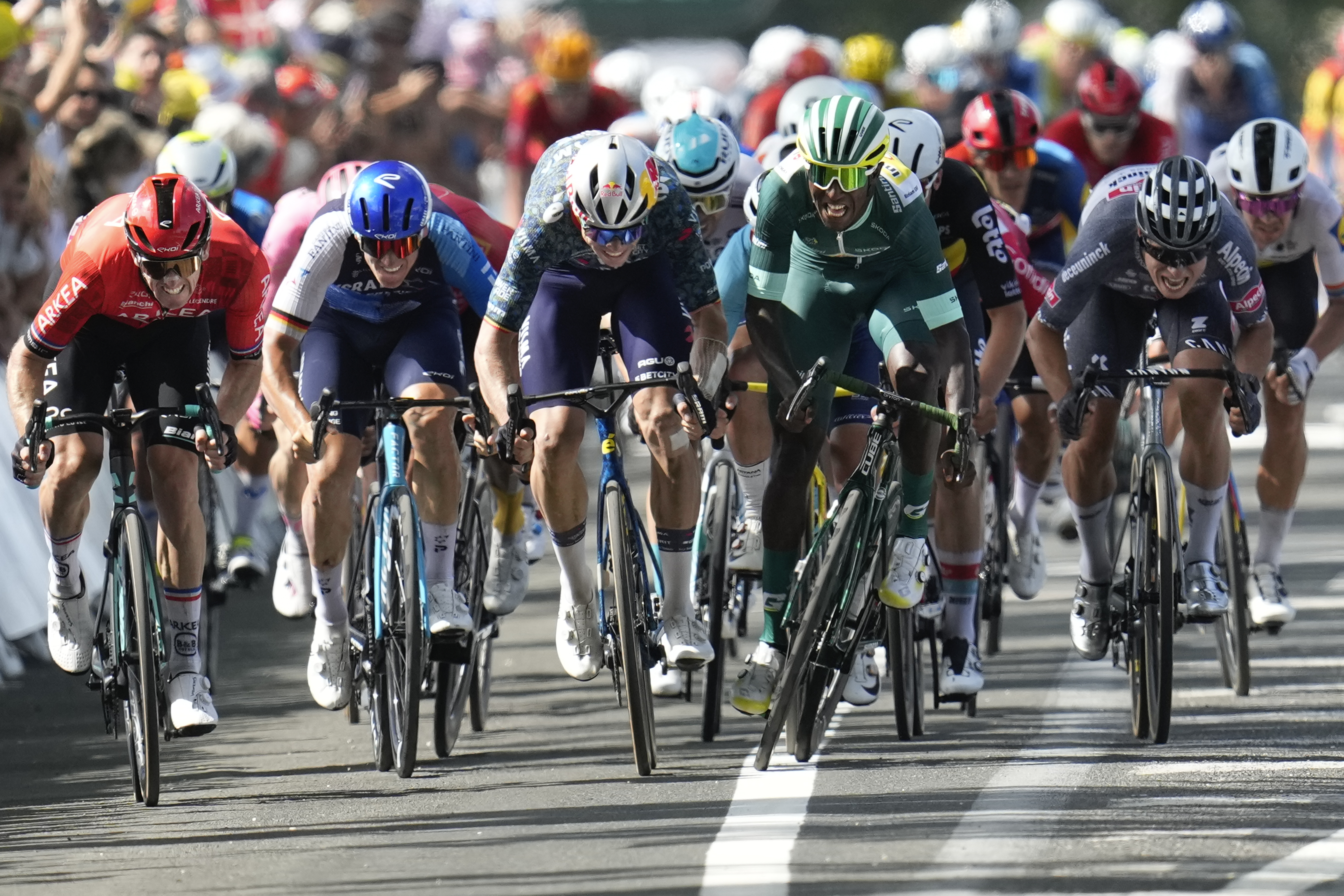 FILE - Eritrea's Biniam Girmay, wearing the best sprinter's green jersey, sprints to the finish line ahead France's Arnaud Demare, far left, Germany's Pascal Ackermann, second left, Belgium's Wout van Aert, third left, and Belgium's Jasper Philipsen, right, to win the twelfth stage of the Tour de France cycling race over 203.6 kilometers (126.5 miles) with start in Aurillac and finish in Villeneuve-sur-Lot, France, Thursday, July 11, 2024.