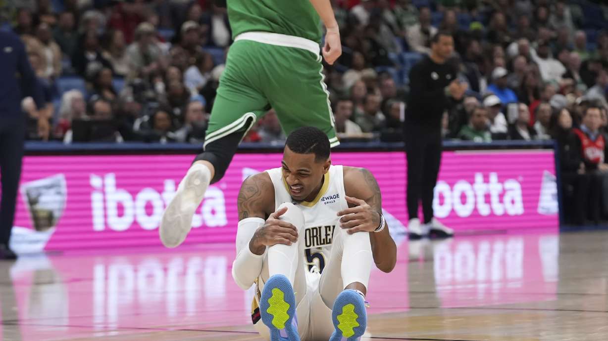 New Orleans Pelicans guard Dejounte Murray (5) reacts after being hurt in the first half of an NBA basketball game against the Boston Celtics in New Orleans, Friday, Jan. 31, 2025.