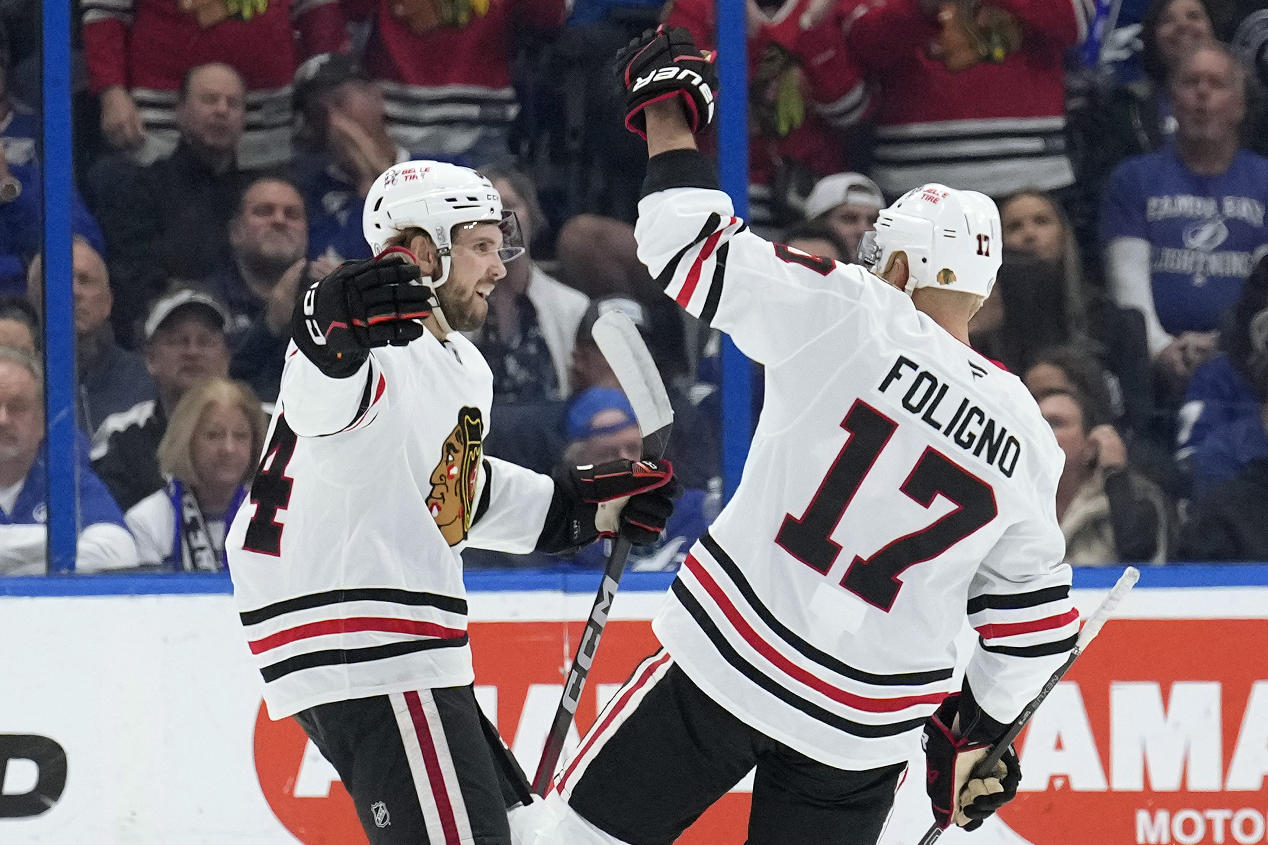 Chicago Blackhawks left wing Landon Slaggert (84) celebrates his goal against the Tampa Bay Lightning with left wing Nick Foligno (17) during the second period of an NHL hockey game Tuesday, Jan. 28, 2025, in Tampa, Fla.