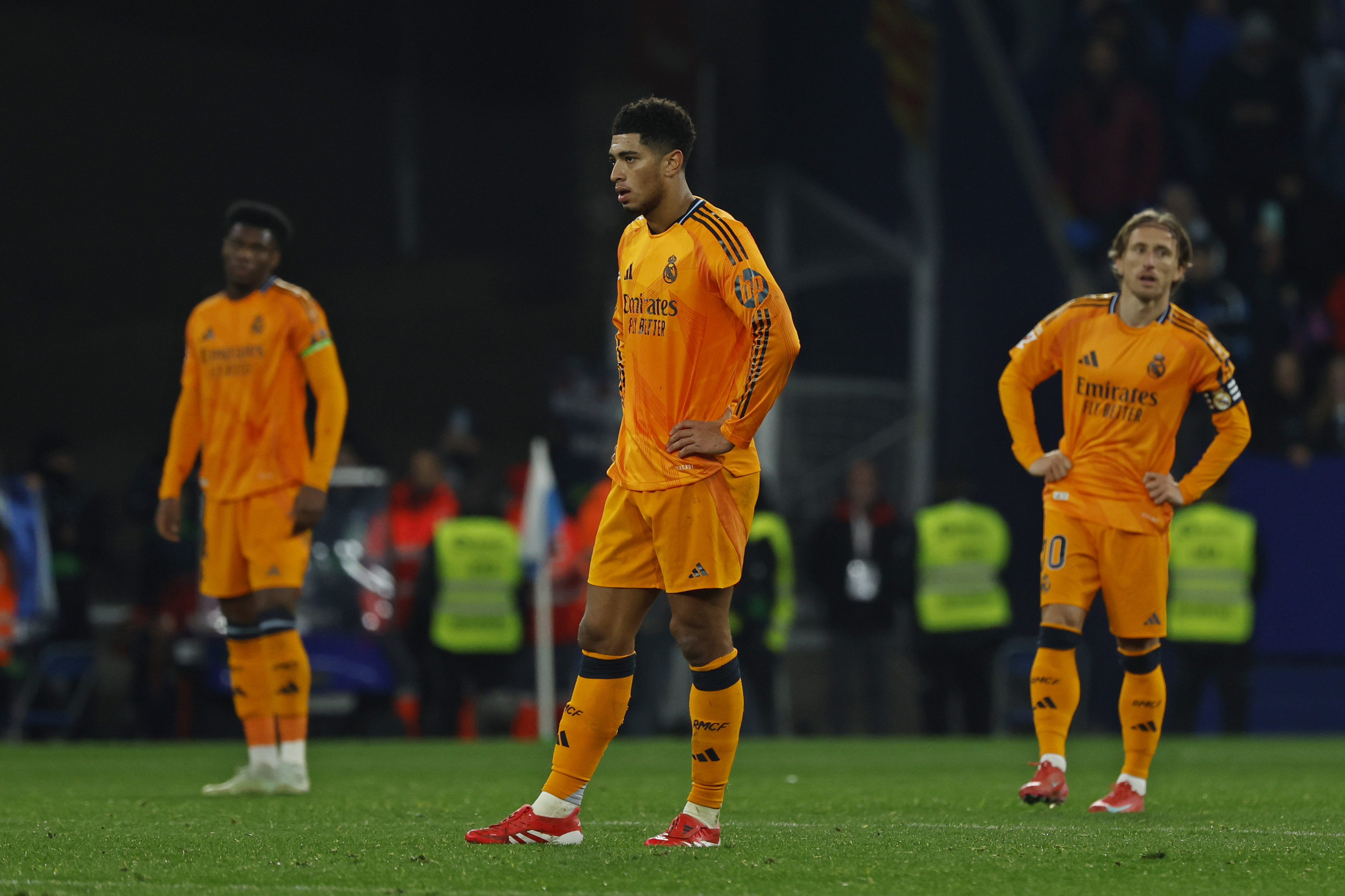 Real Madrid's Jude Bellingham, centre and Luka Modric, right, react after Espanyol's Carlos Romero scored the opening goal during a Spanish La Liga soccer match between Espanyol and Real Madrid at the Lluis Companys Olympic Stadium in Barcelona, Spain, Saturday Feb.1, 2025. 
