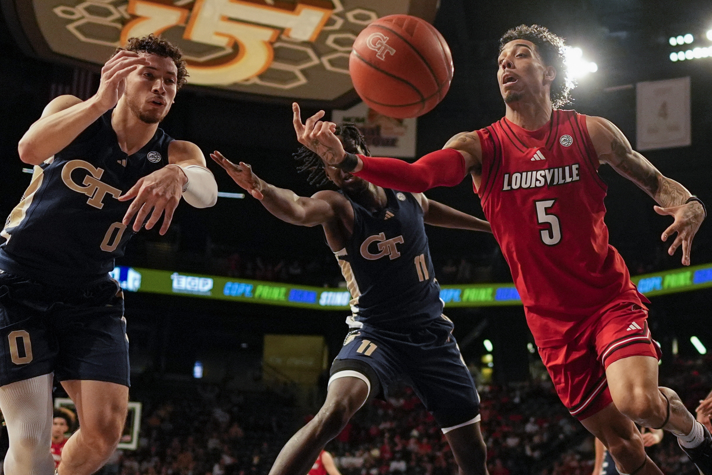 Louisville guard Terrence Edwards Jr. (5) vies for a loose ball against Georgia Tech forward Baye Ndongo (11) during the first half of an NCAA basketball game, Saturday, Feb. 1, 2025, in Atlanta. 