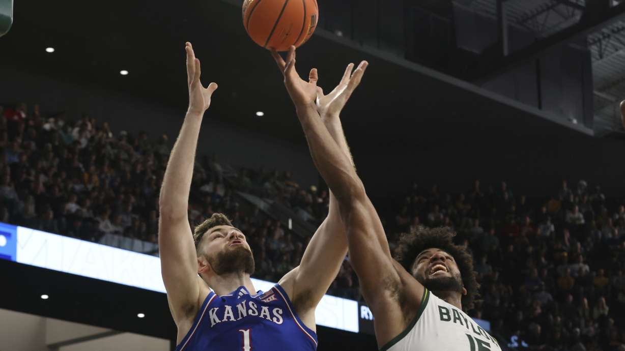 Kansas center Hunter Dickinson and Baylor forward Norchad Omier reach for a loose ball during the first half of an NCAA college basketball game Saturday, Feb. 1, 2025, in Waco, Texas.