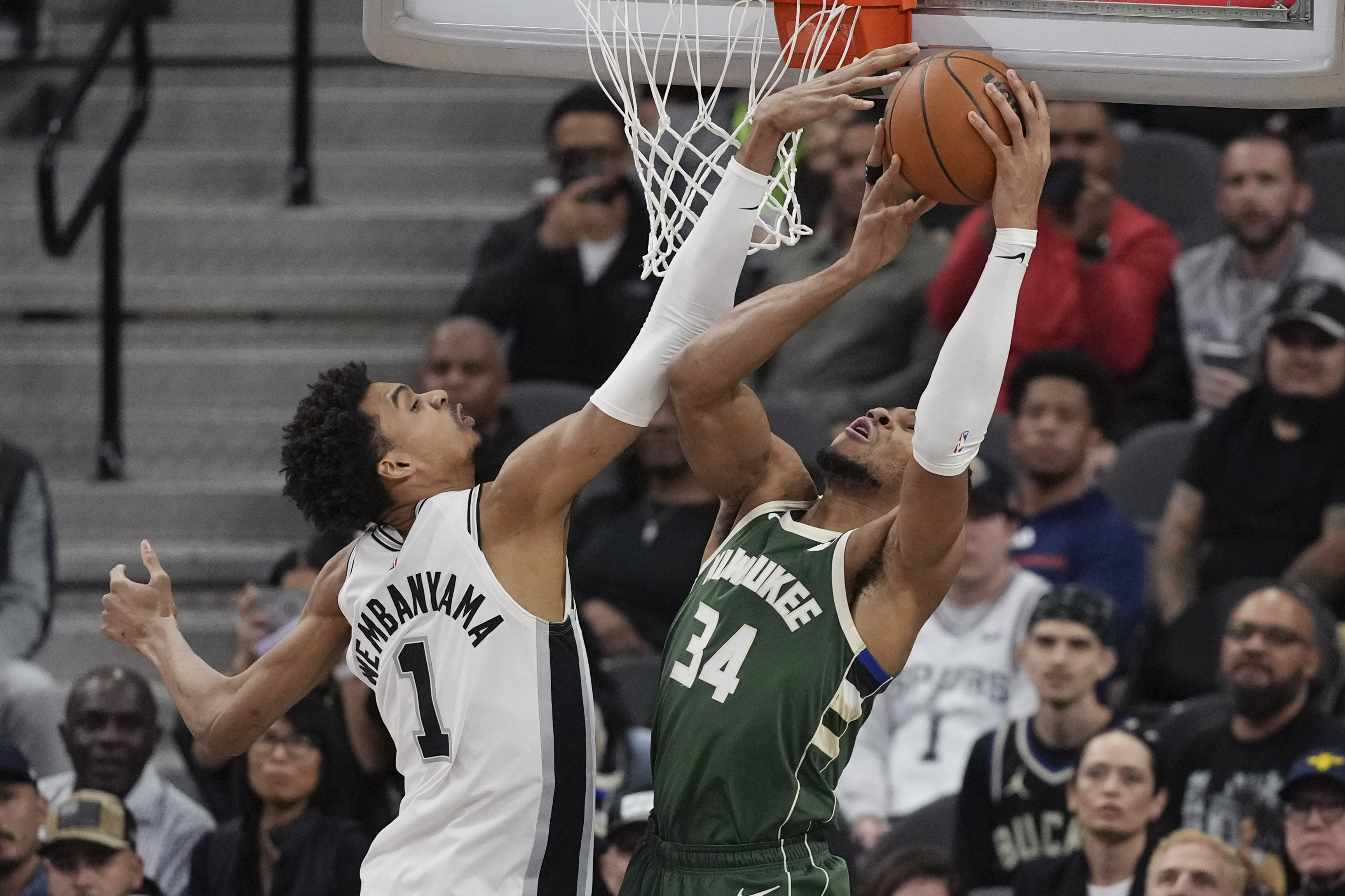 Milwaukee Bucks forward Giannis Antetokounmpo (34) is blocked by San Antonio Spurs center Victor Wembanyama (1) during the first half of an NBA basketball game in San Antonio, Friday, Jan. 31, 2025. 
