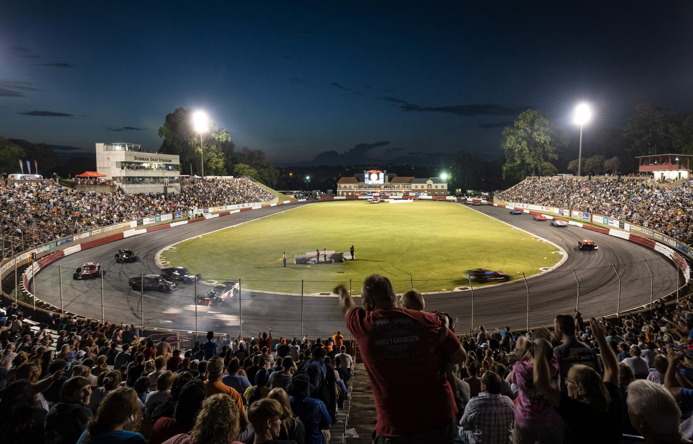 FILE - Race fans react as driver Burt Myers gets caught up between turns one and two during the 100-lap Modified race on Saturday, July 22, 2023, at Bowman Gray Stadium in Winston-Salem, N.C. 