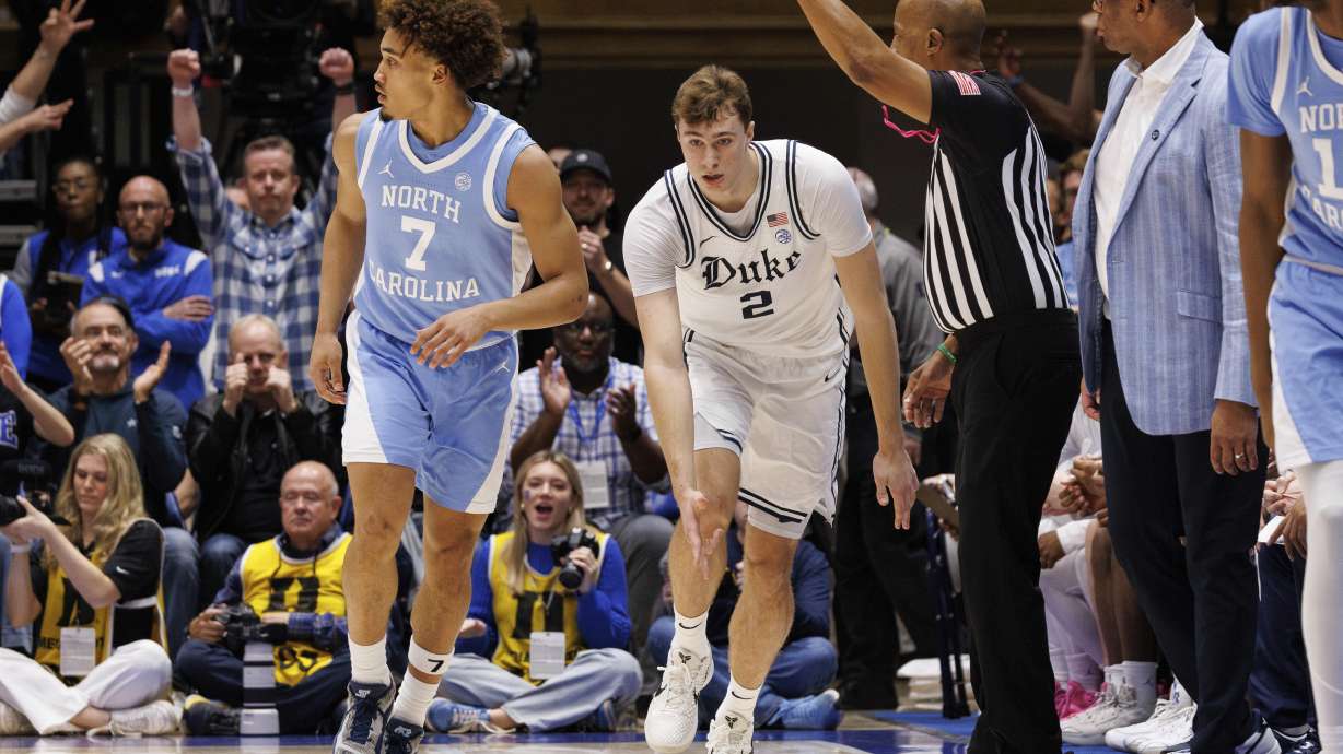 Duke's Cooper Flagg (2) celebrates after hitting a 3-point basket against North Carolina's Seth Trimble (7) during the first half of an NCAA college basketball game in Durham, N.C., Saturday, Feb. 1, 2025.