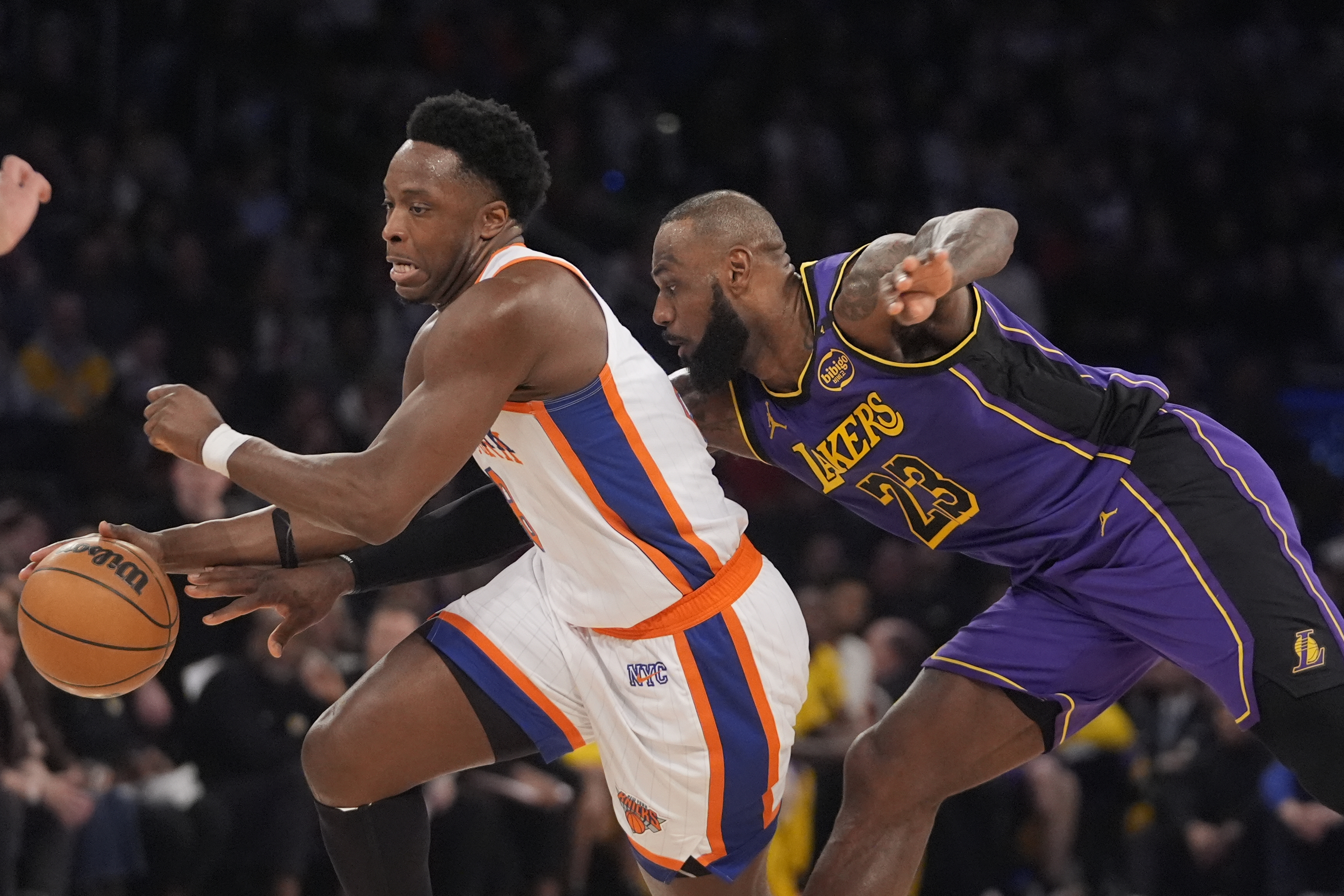 New York Knicks' OG Anunoby (8) drives past Los Angeles Lakers' LeBron James (23) during the first half of an NBA basketball game Saturday, Feb. 1, 2025, in New York.