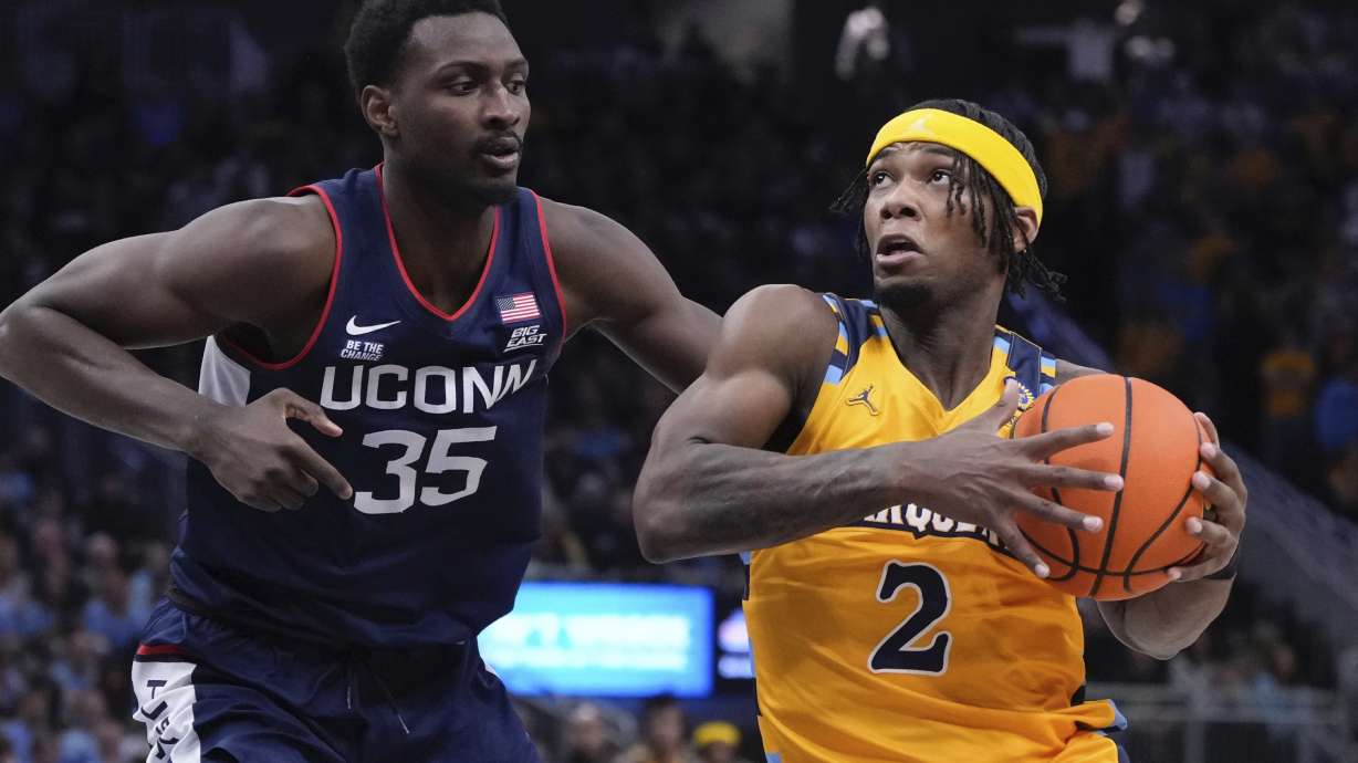 Marquette's Chase Ross gets past UConn's Samson Johnson during the first half of an NCAA college basketball game Saturday, Feb. 1, 2025, in Milwaukee.
