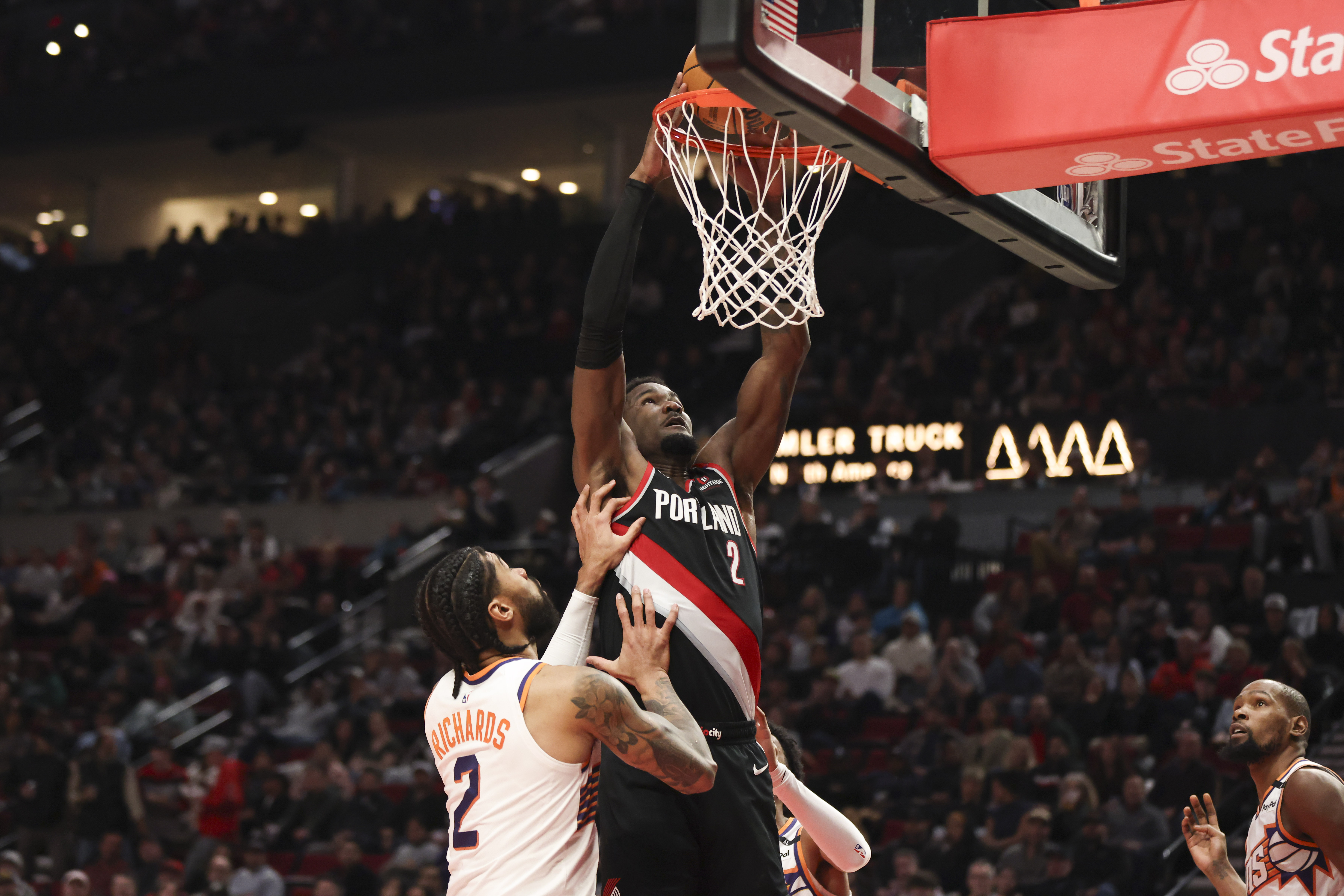 Portland Trail Blazers center Deandre Ayton (2) dunks over Phoenix Suns center Nick Richards (2) during the first half of an NBA basketball game Saturday, Feb. 1, 2025, in Portland, Ore. 