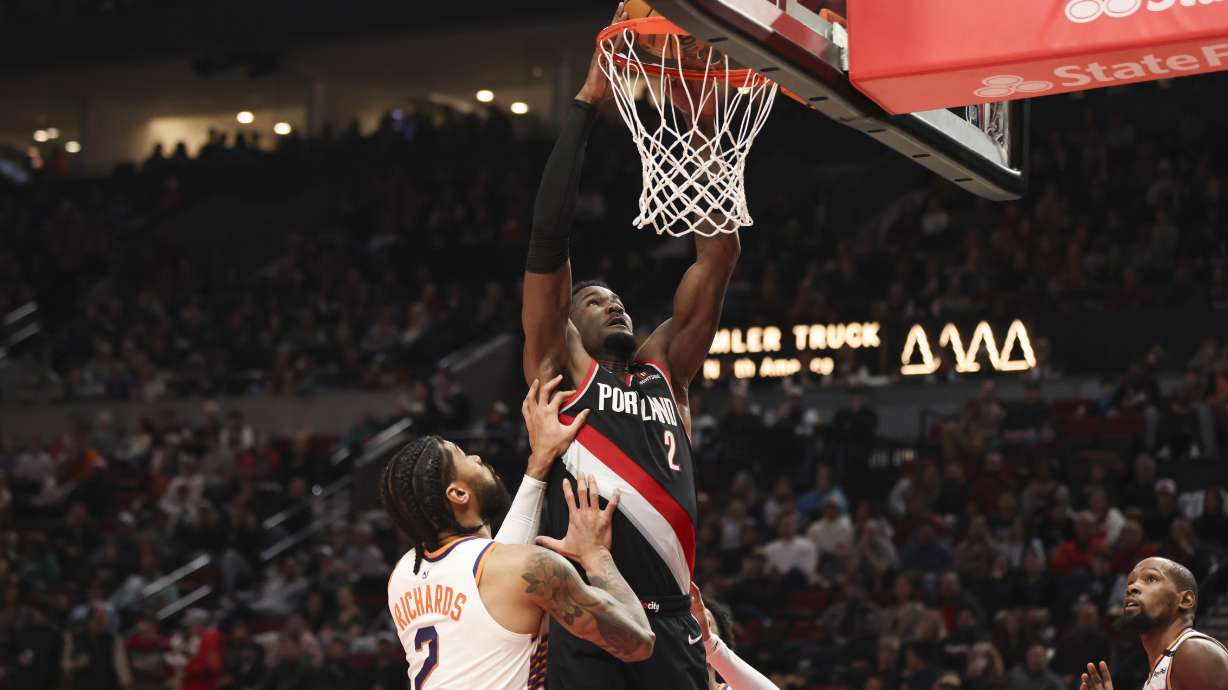 Portland Trail Blazers center Deandre Ayton (2) dunks over Phoenix Suns center Nick Richards (2) during the first half of an NBA basketball game Saturday, Feb. 1, 2025, in Portland, Ore.