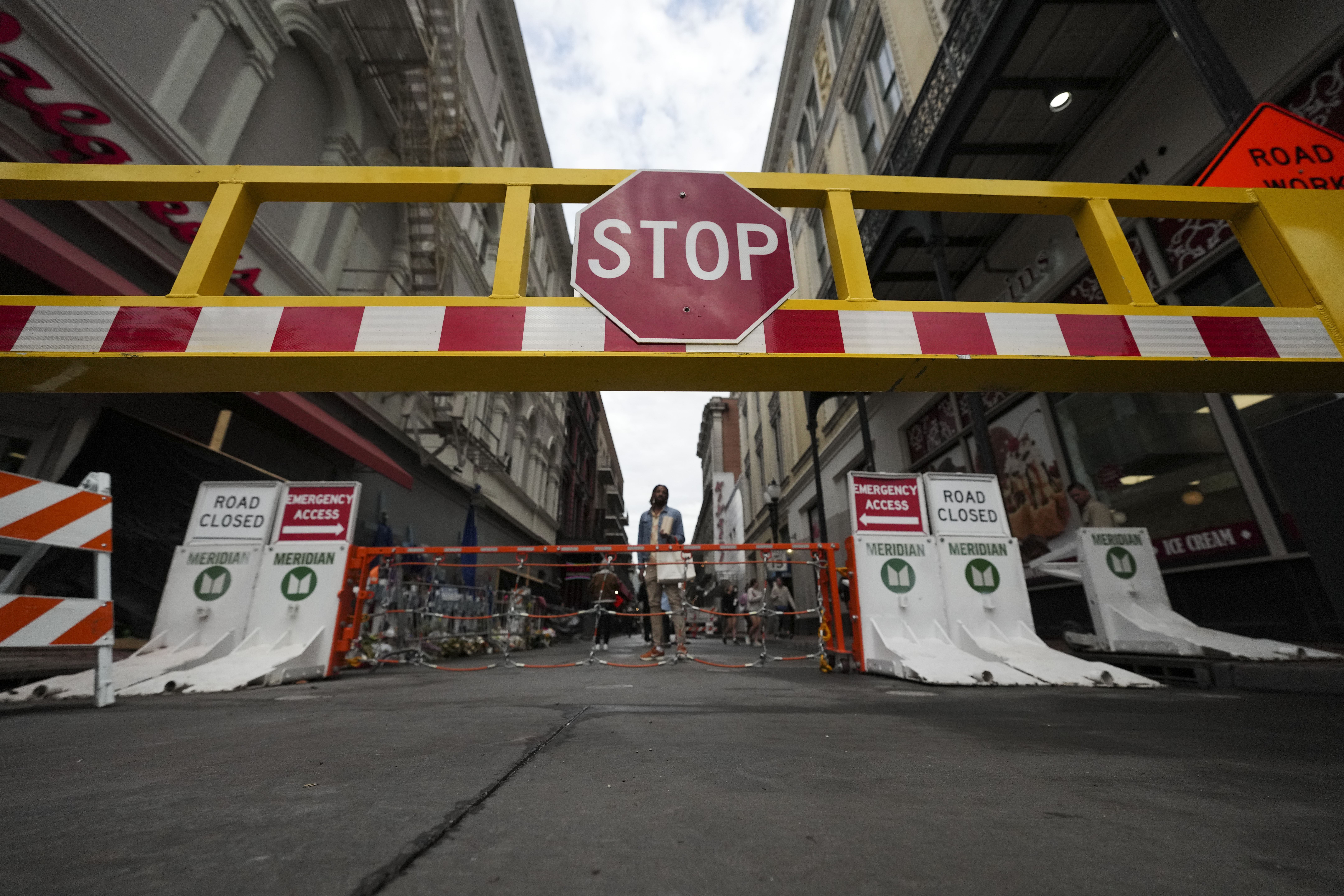 Newly installed security barriers are seen on Bourbon Street next to a memorial for victims of the Jan. 1 car attack ahead of the Super Bowl in New Orleans, Friday, Jan. 31, 2025. 