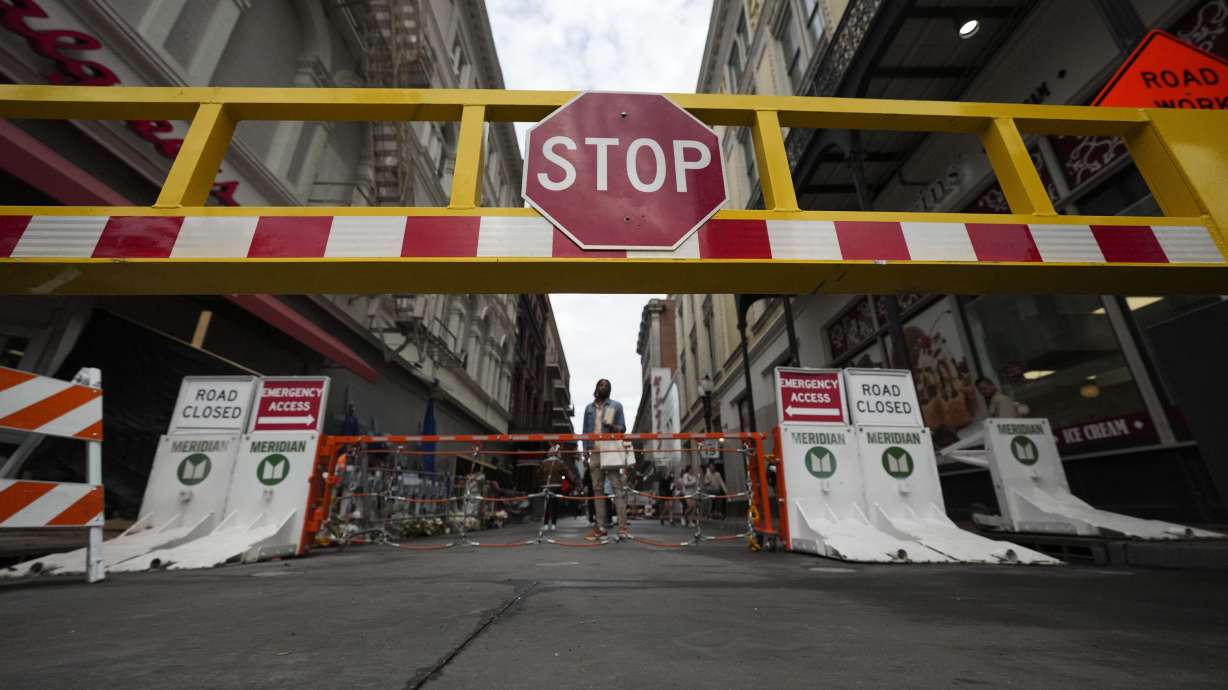 Newly installed security barriers are seen on Bourbon Street next to a memorial for victims of the Jan. 1 car attack ahead of the Super Bowl in New Orleans, Friday, Jan. 31, 2025.
