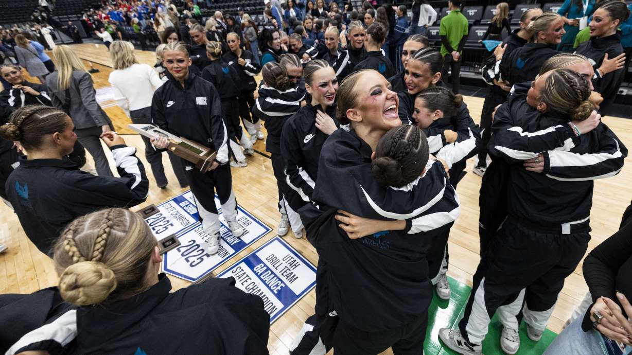 Members of the Farmington High School drill team celebrate with the state championship trophy after Farmington won overall to become the 6A champions during the UHSAA 6A State Drill Team Finals held at the UCCU Center in Orem on Saturday, Feb. 1, 2025.