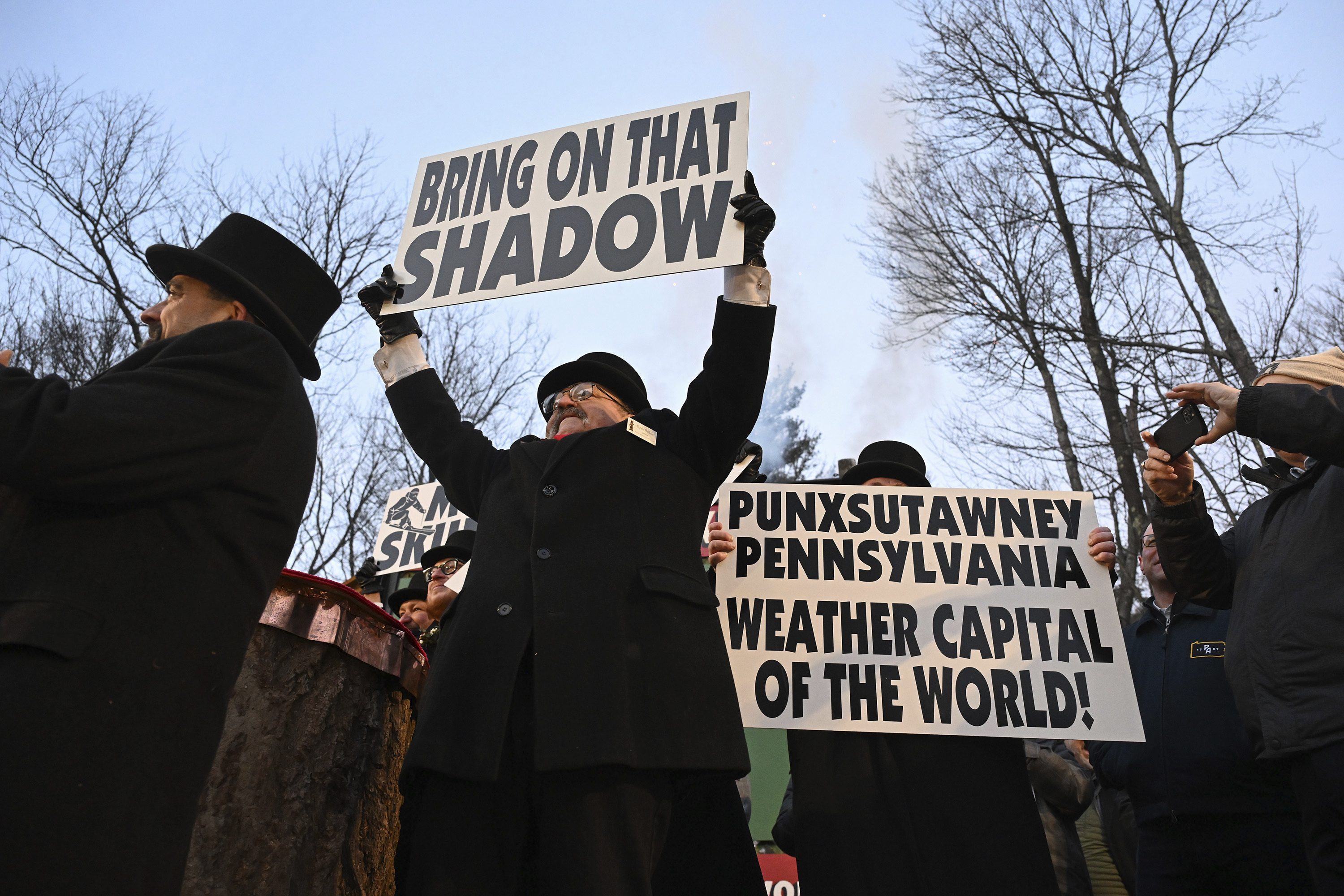 Groundhog Club member Butch Philliber displays a sign following the forecast by Punxsutawney Phil, the weather prognosticating groundhog, during the 139th celebration of Groundhog Day on Gobbler's Knob in Punxsutawney, Pa., Sunday.