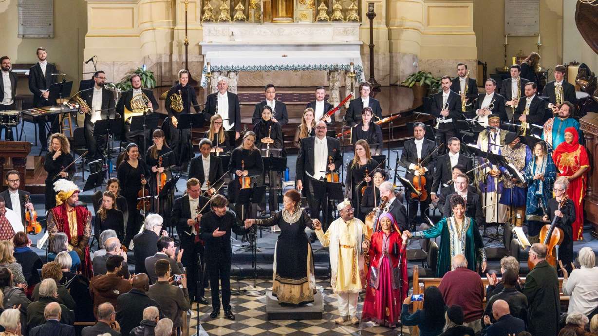 The Louisiana Philharmonic Orchestra, led by conductor Patrick Dupre Quigley, along with a group of singers stand following a Jan. 24 preview of the opera in New Orleans.