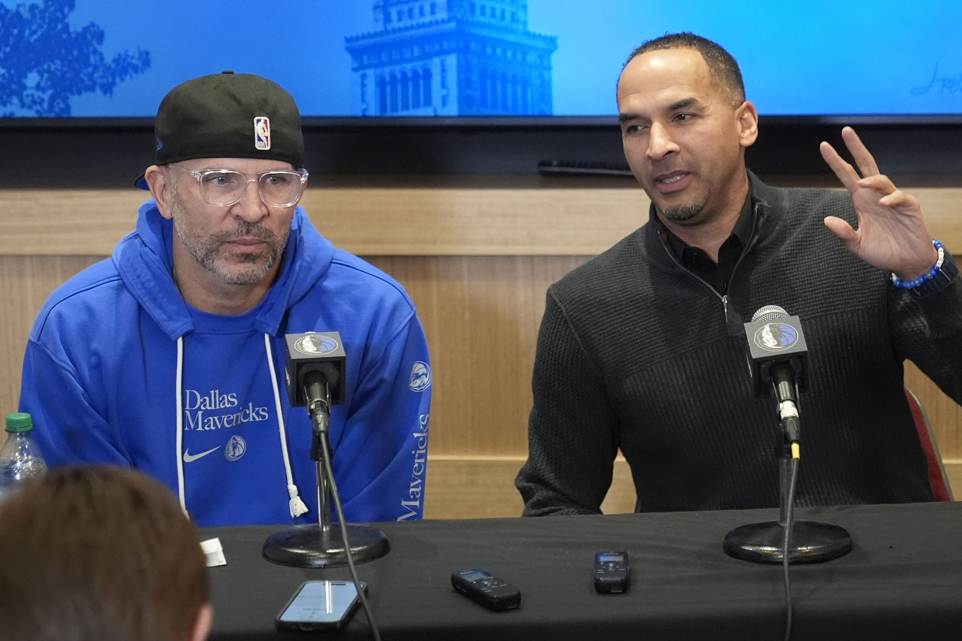 Dallas Mavericks head coach Jason Kidd, left, and general manager Nico Harrison, right, discuss the trade of Luka Doncic before an NBA basketball game against the Cleveland Cavaliers, Sunday, Feb. 2, 2025, in Cleveland. 