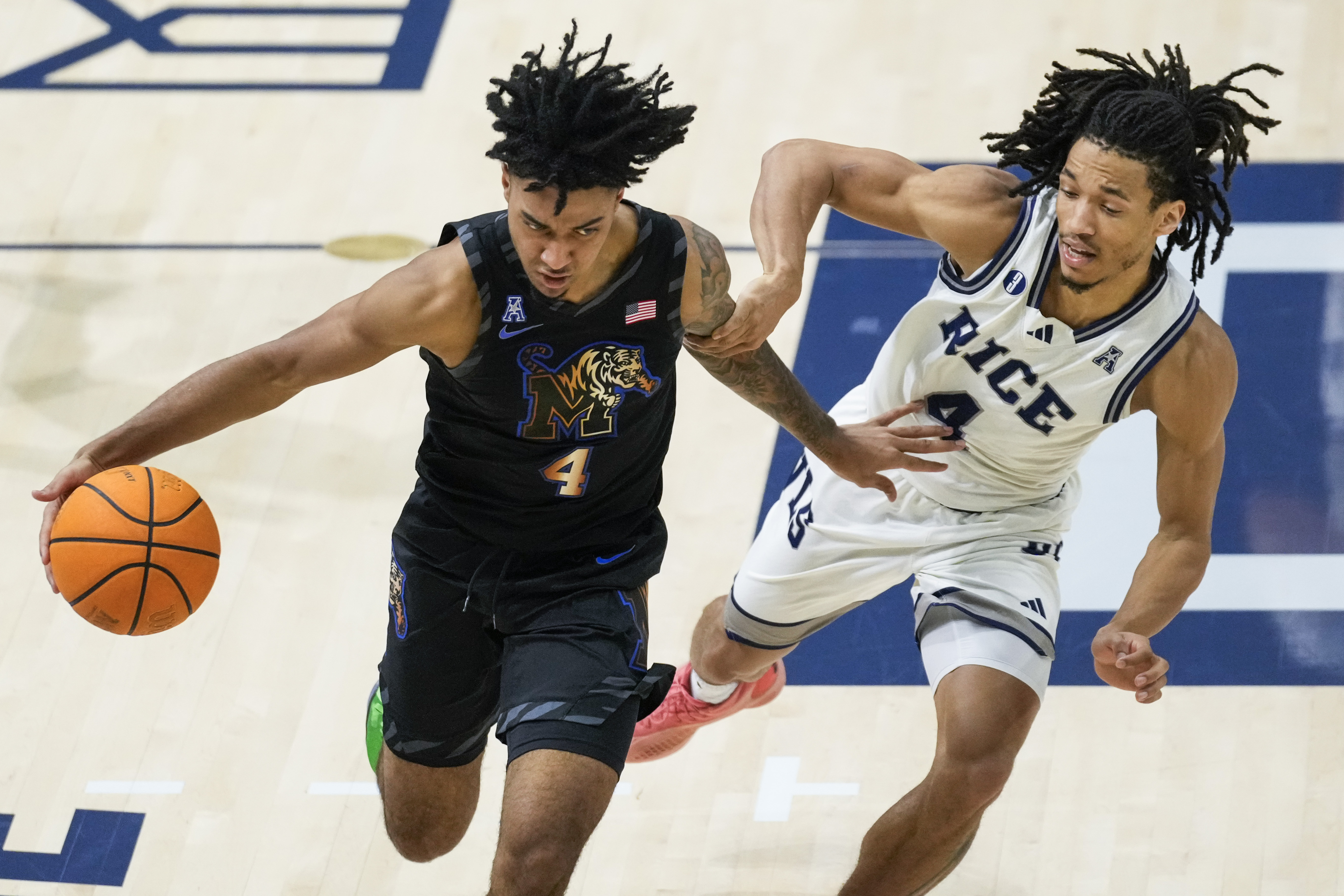 Rice guard Denver Anglin, right, defends against Memphis guard PJ Haggerty (4) during the first half of an NCAA college basketball game in Houston, Sunday, Feb. 2, 2025. 